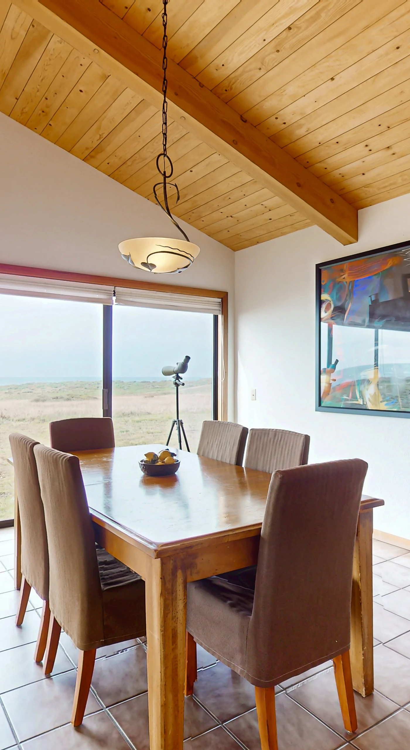 Enjoy meals with a view in this charming dining area, where sunlight dances off the table and the ocean beckons just beyond.