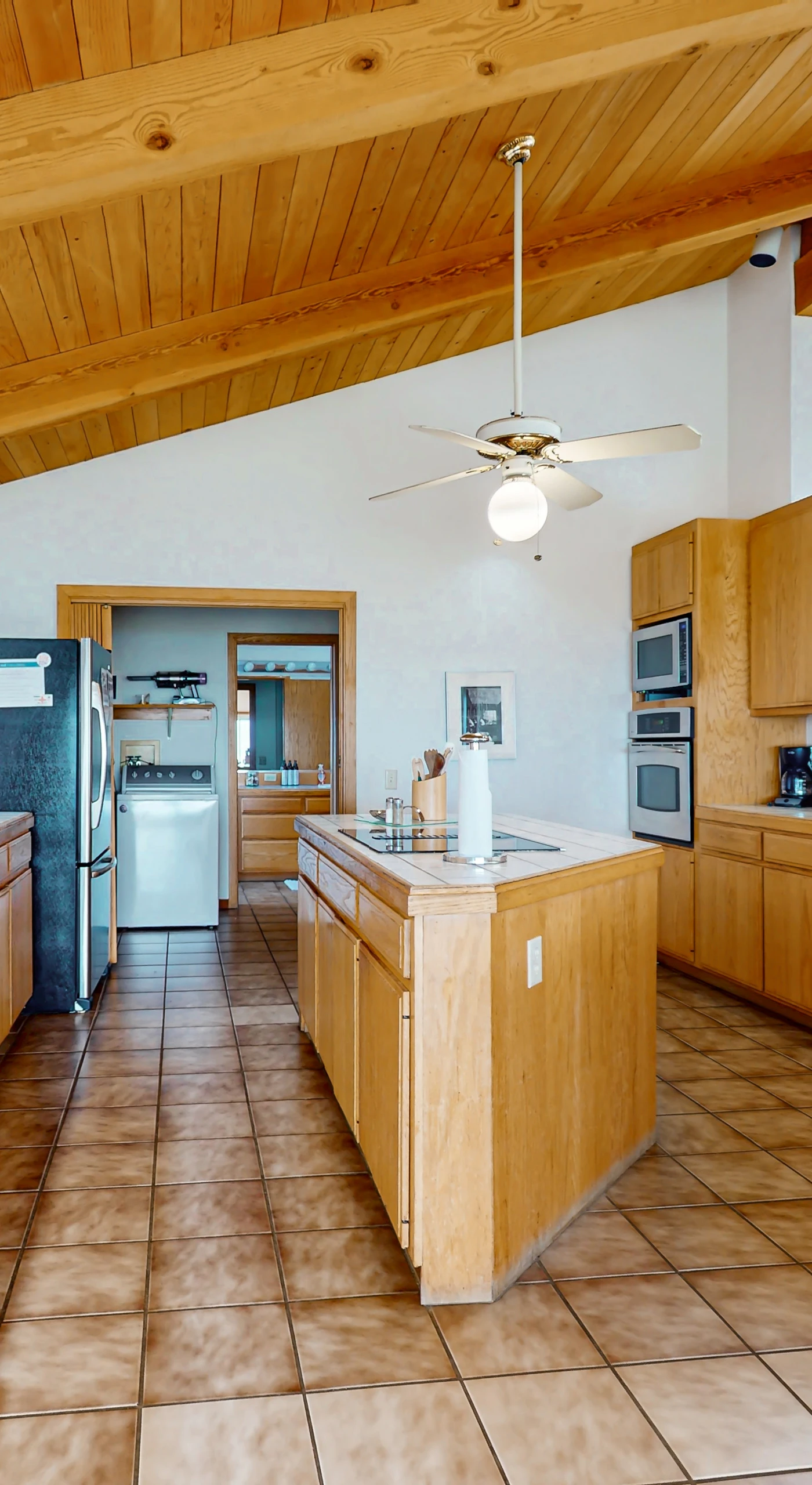 Unleash your culinary creativity in this spacious kitchen, where ample counter space and natural light inspire delicious meals with ocean views.