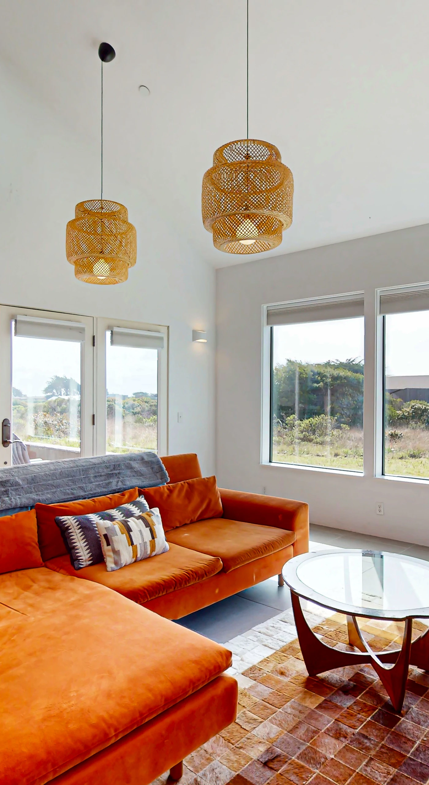 Relax in this beautifully designed living area, where you can enjoy the coastal views through expansive windows while basking in the afternoon light.