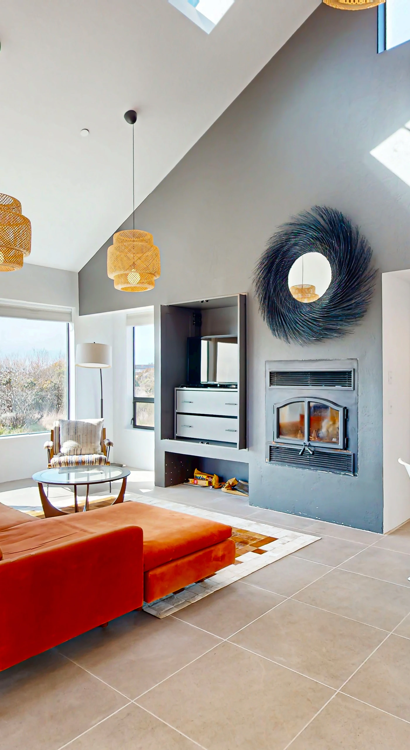 Gather in the spacious living room, where natural light floods the space, creating a warm atmosphere for cozy evenings by the wood-burning fireplace.