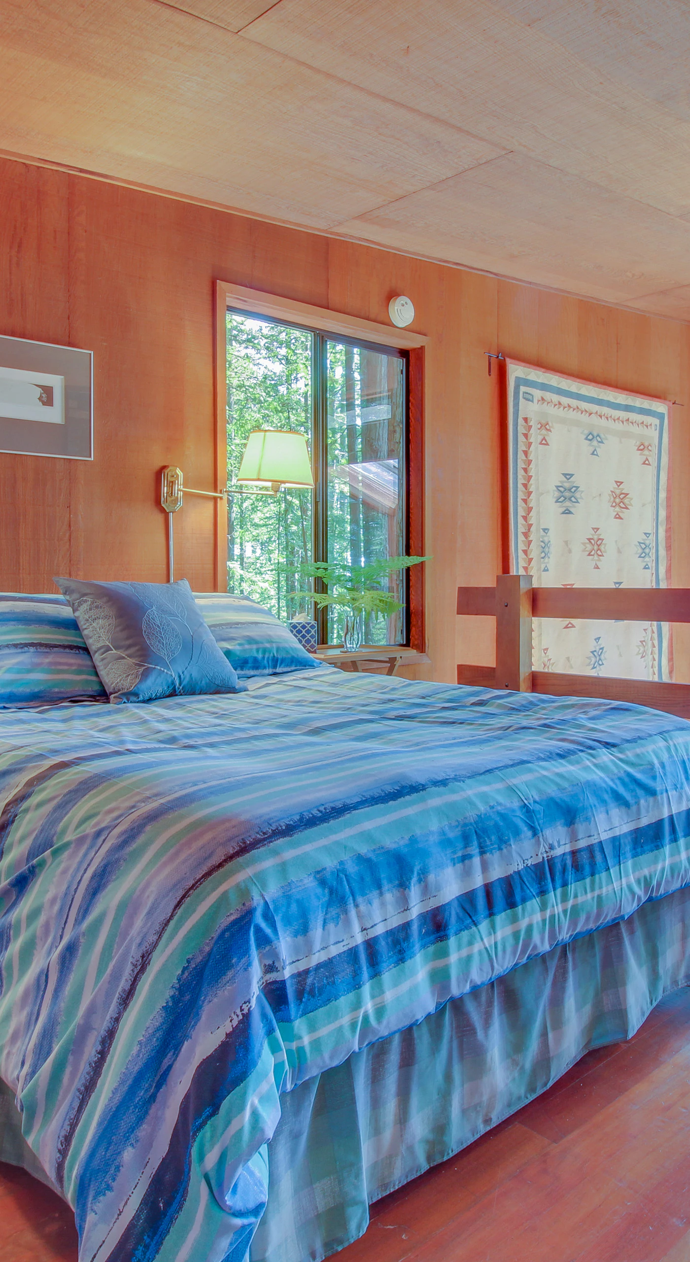Wake up surrounded by nature in this serene master bedroom, where sunlight dances through the windows and a gentle breeze invites relaxation.