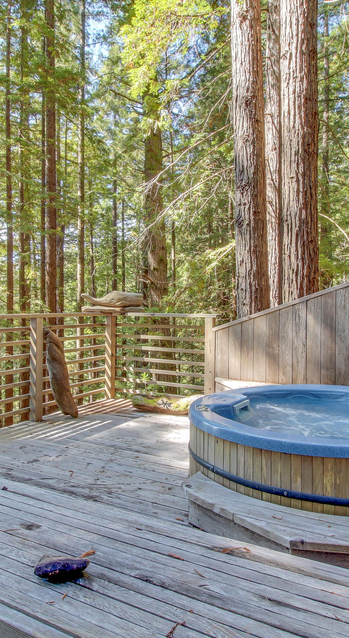 Indulge in relaxation in your private hot tub, nestled among the trees for a truly tranquil experience.