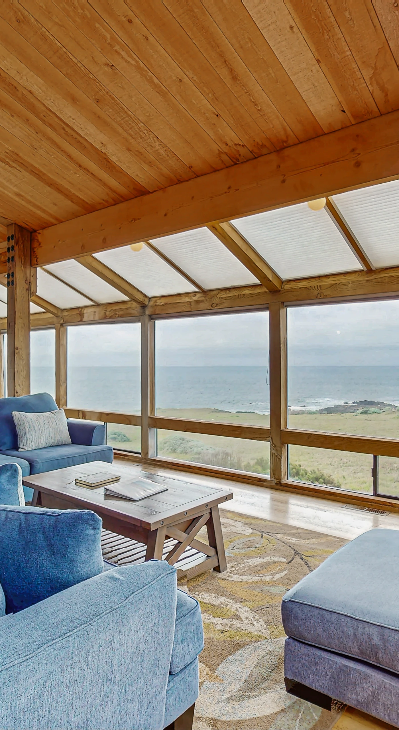 Morning light fills the spacious living room, where you can unwind with ocean views and comfy seating.