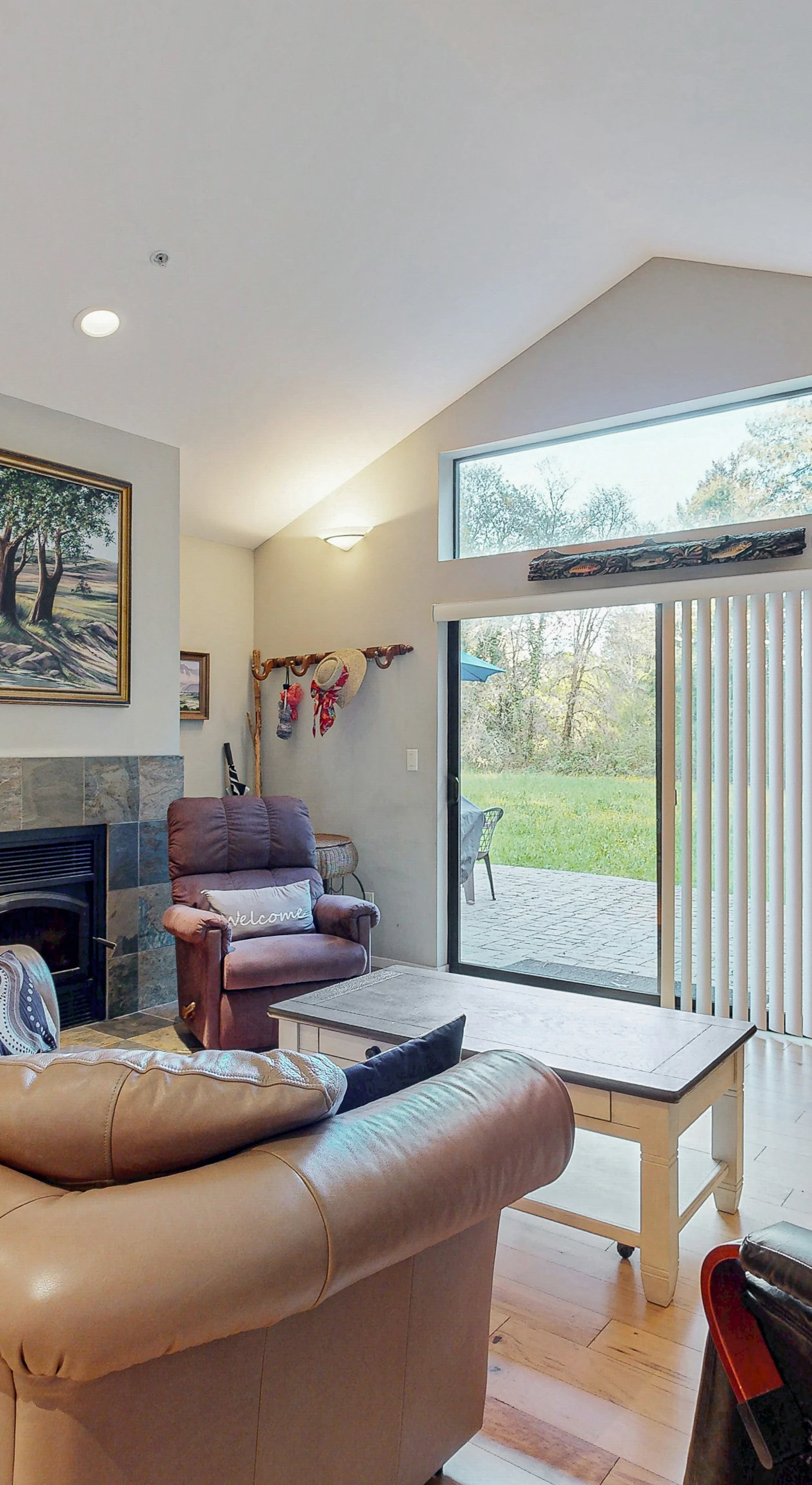 Unwind by the gas fireplace in your spacious living room with vaulted ceilings and sliding glass doors opening to the garden.