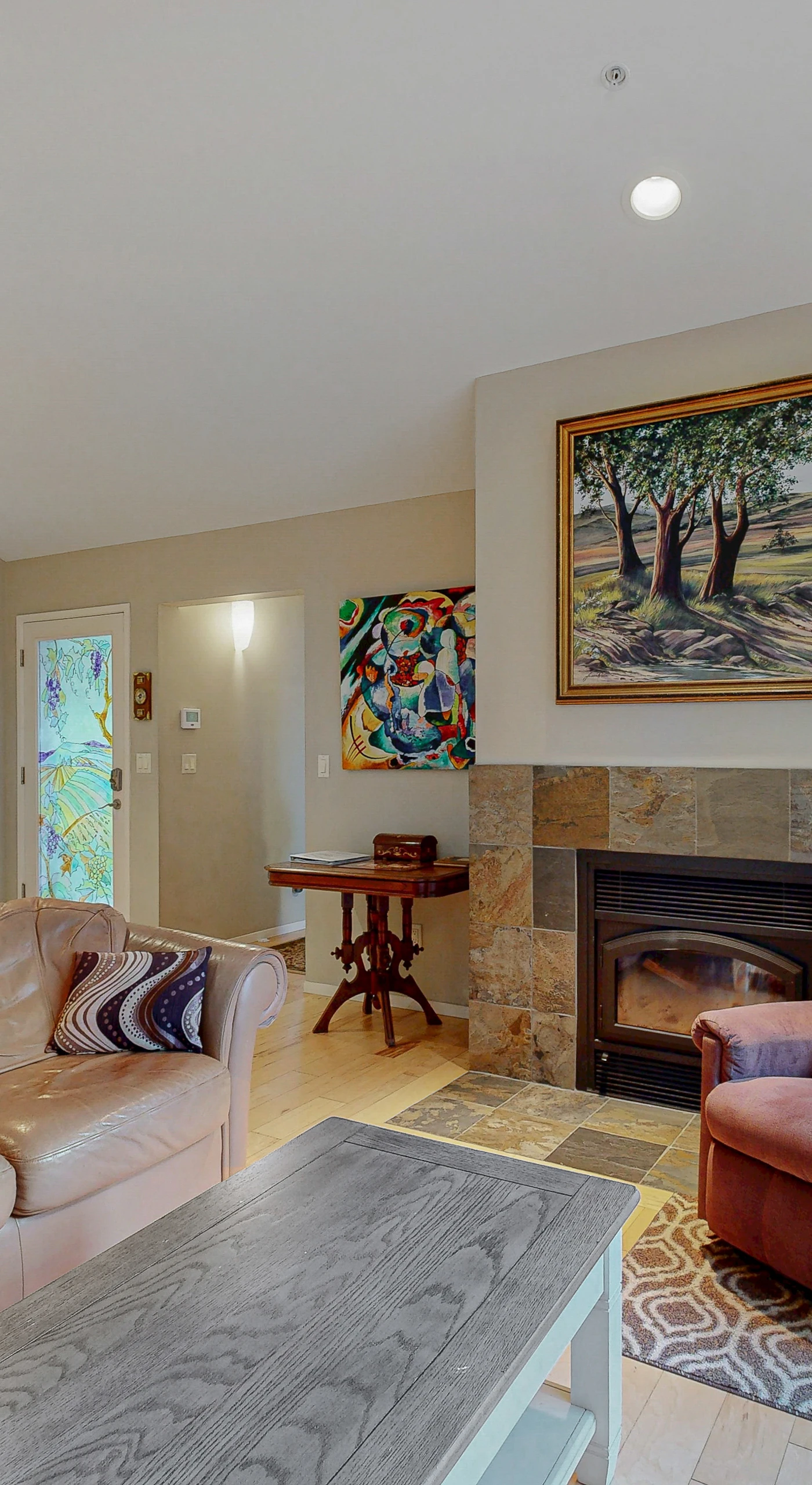 Gather your group around the stone fireplace after a day exploring Sonoma County vineyards — plush seating and local art set the scene.