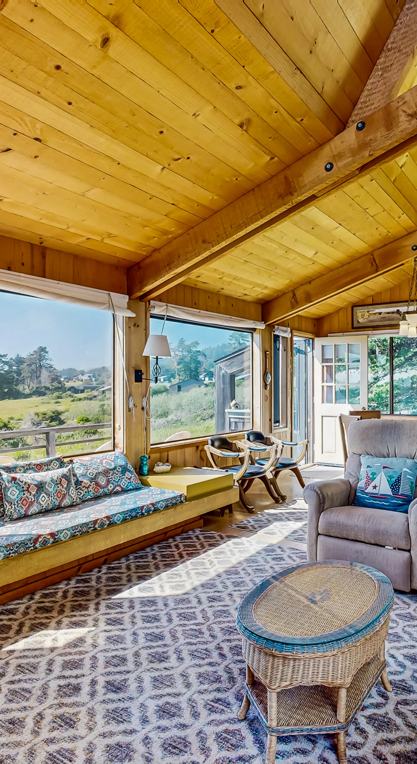 Morning light fills the cozy living room, creating a perfect spot to unwind with a book and enjoy the tranquil surroundings.