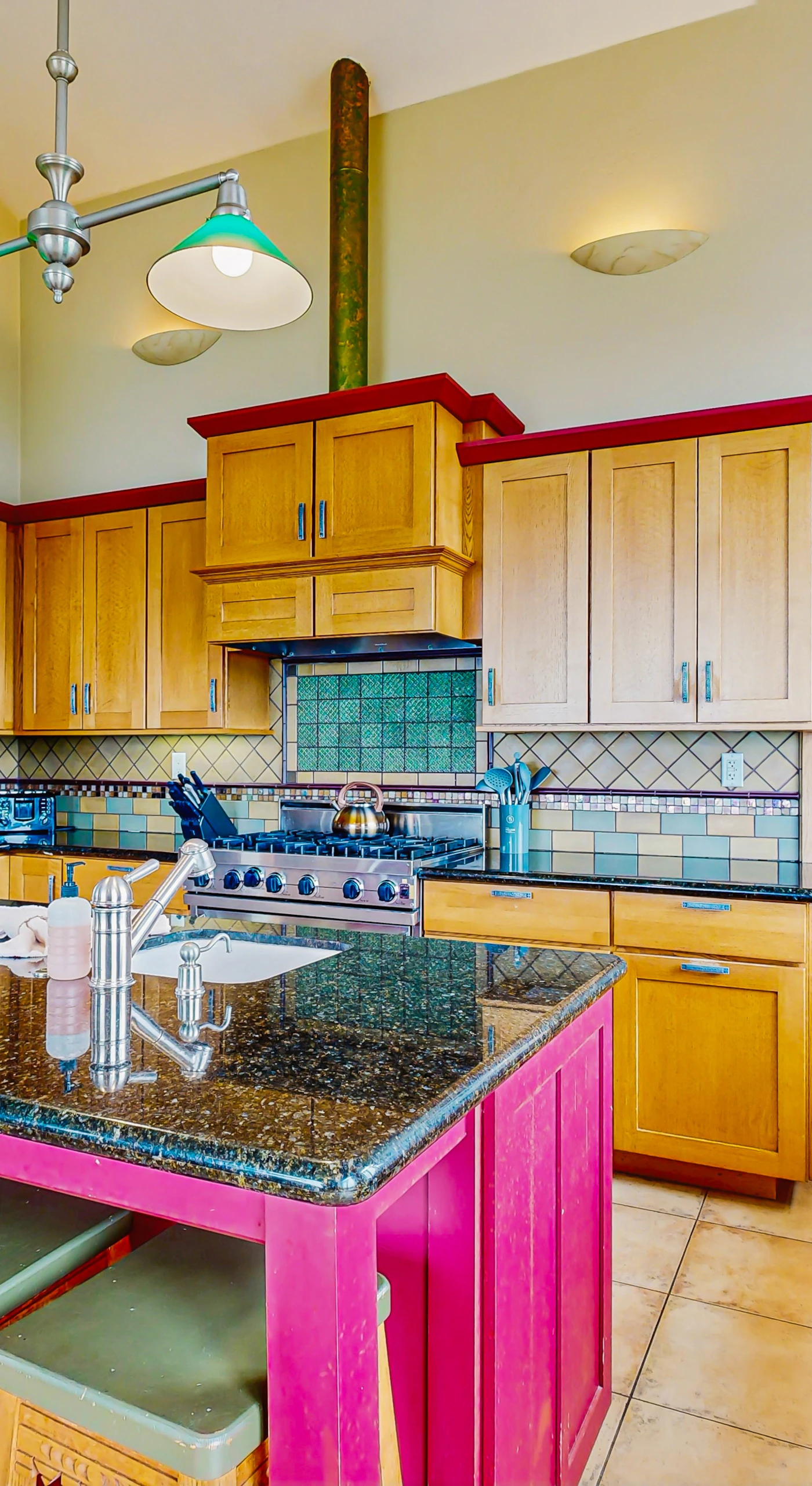 Unleash your culinary creativity in this vibrant kitchen, complete with modern appliances and ample space for preparing delicious meals with ocean views.
