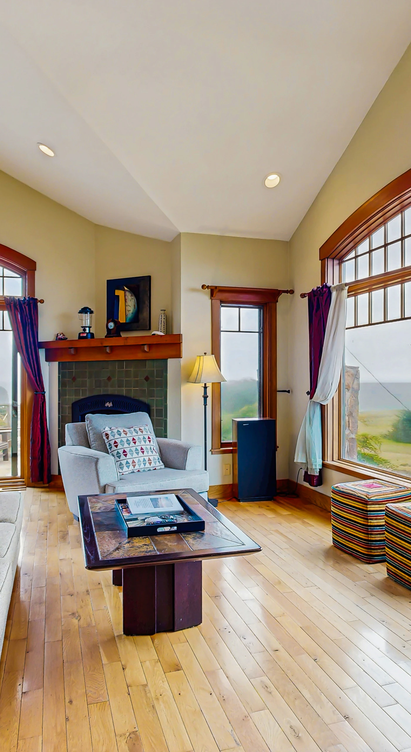 The living room invites you to unwind by the gas fireplace, with large windows framing stunning ocean vistas that change with the tides.