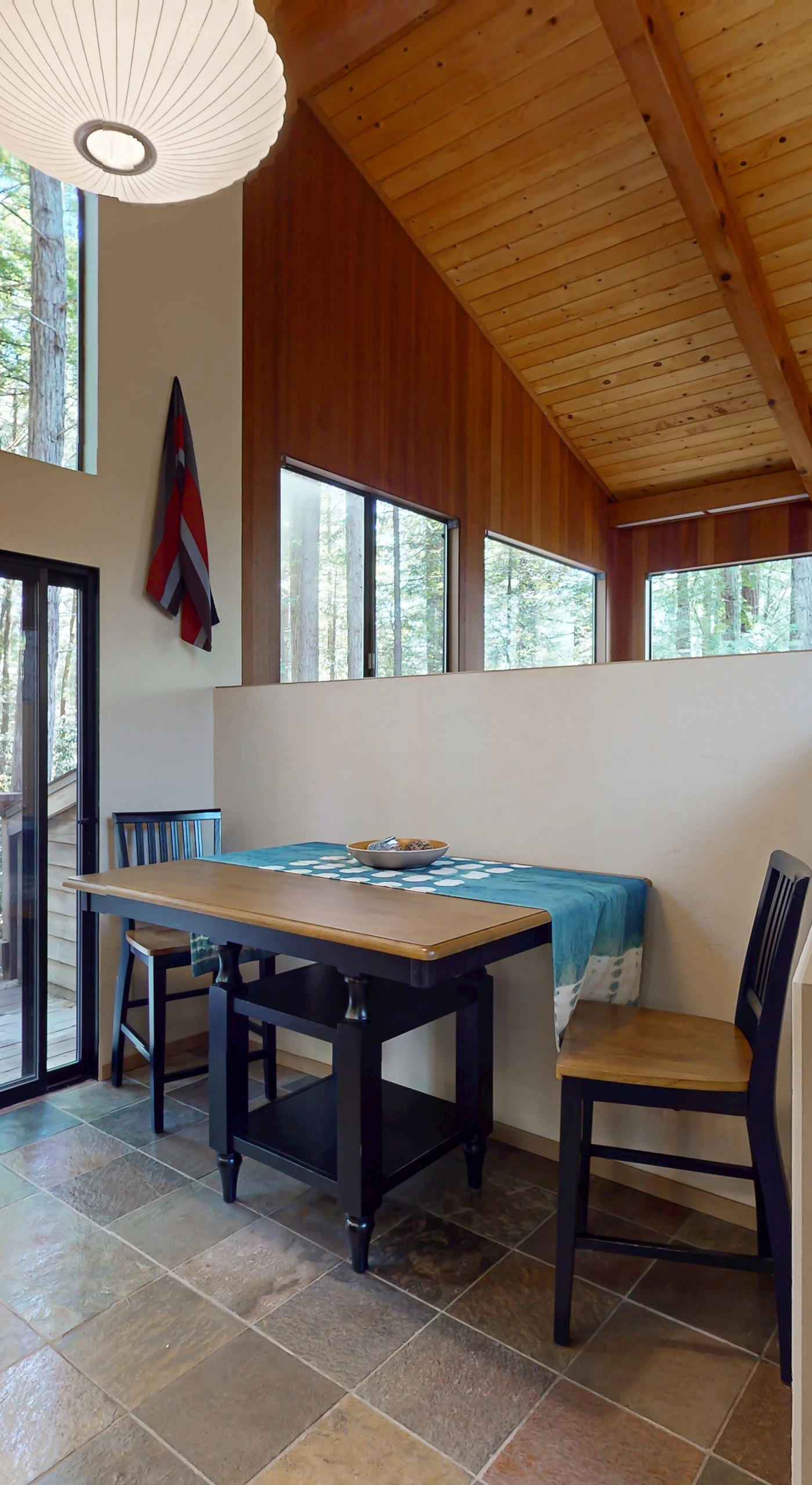 Bright and inviting, this dining area beckons you to savor meals while enjoying views of the surrounding redwoods.