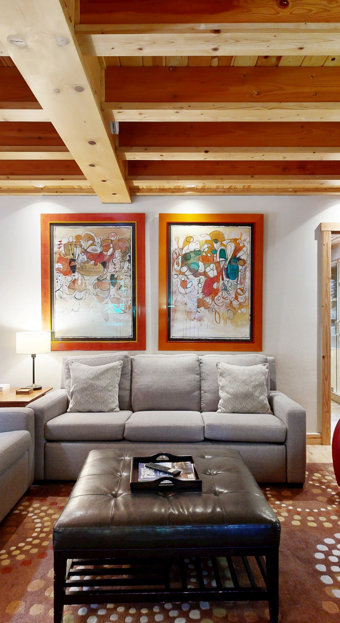 Curl up with a Sonoma County red beneath gallery-worthy art and golden beam ceilings — every angle of your living room invites relaxation.