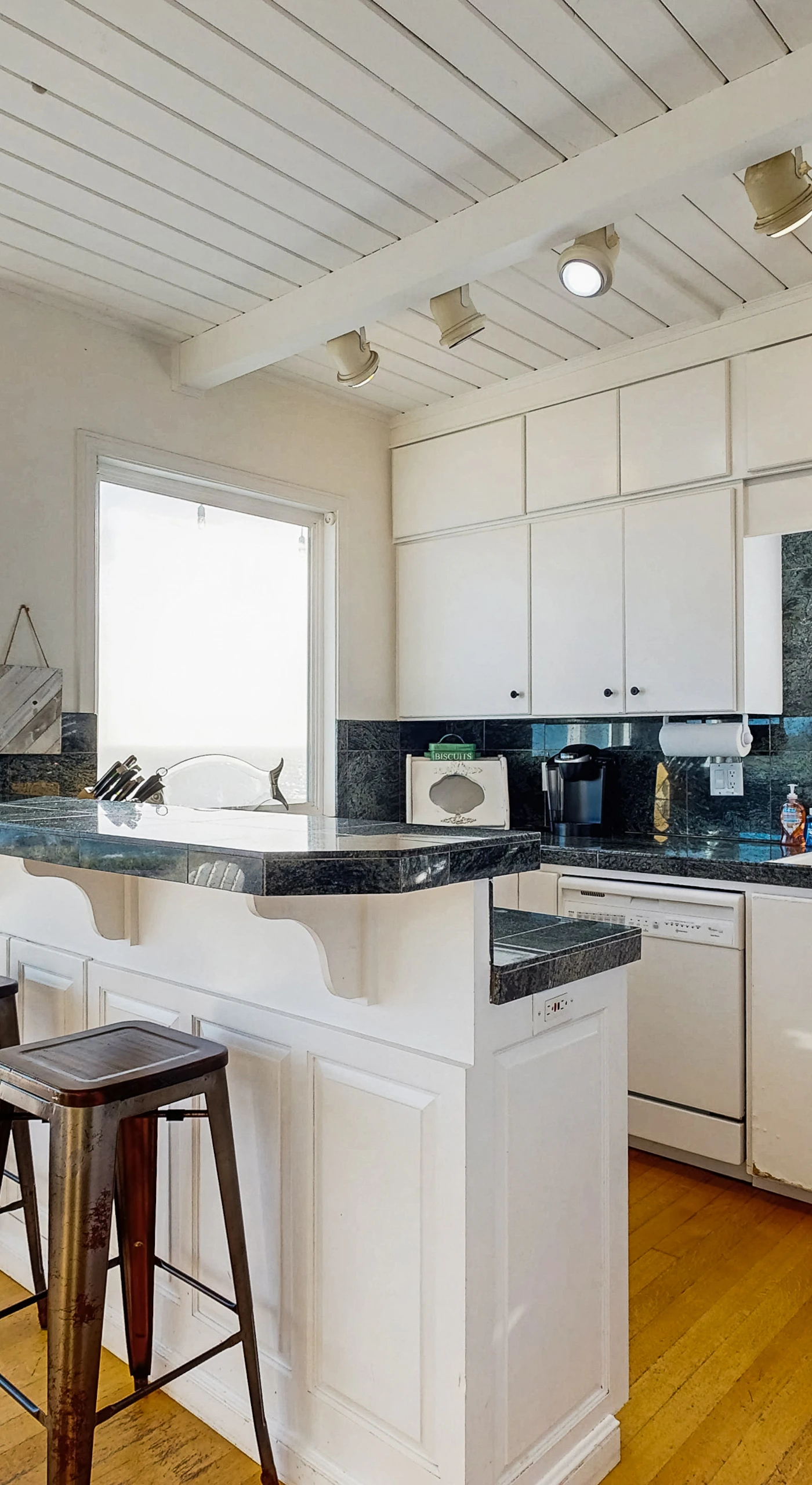 Cook with a view — your fully equipped kitchen features granite counters, breakfast bar, and Pacific Ocean vistas