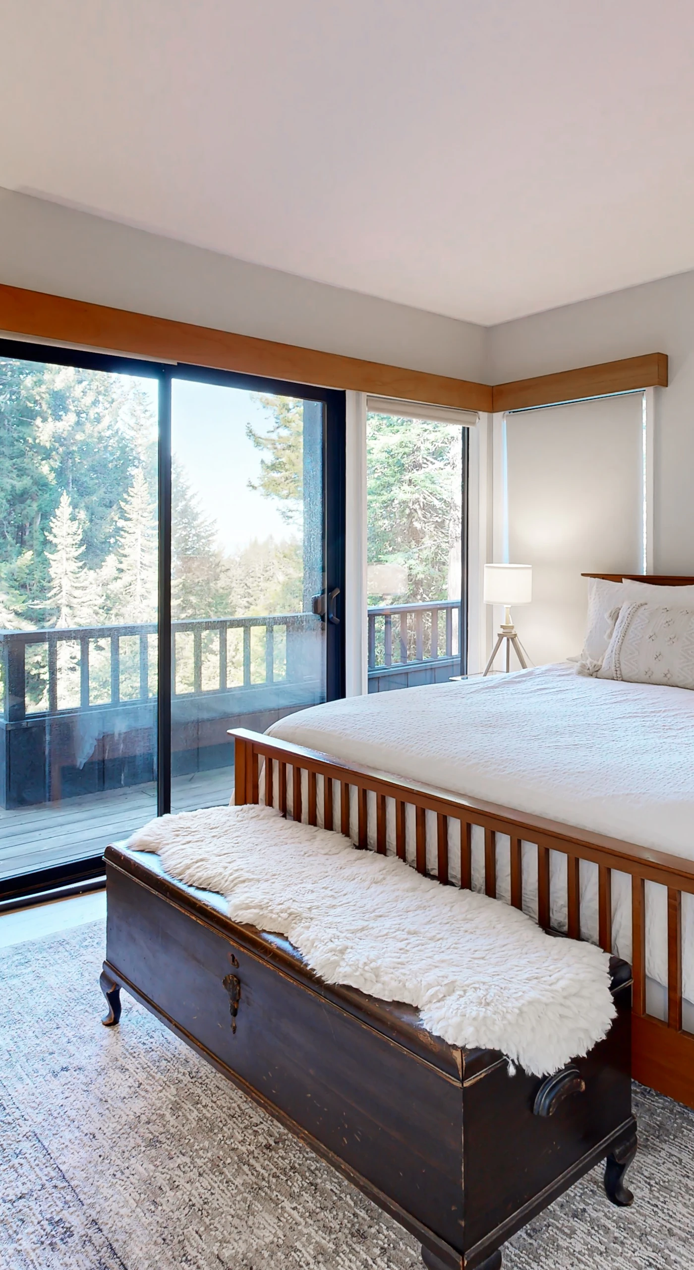 Awaken in the master bedroom, where serene views and elegant decor create a peaceful retreat, just steps away from your private deck.