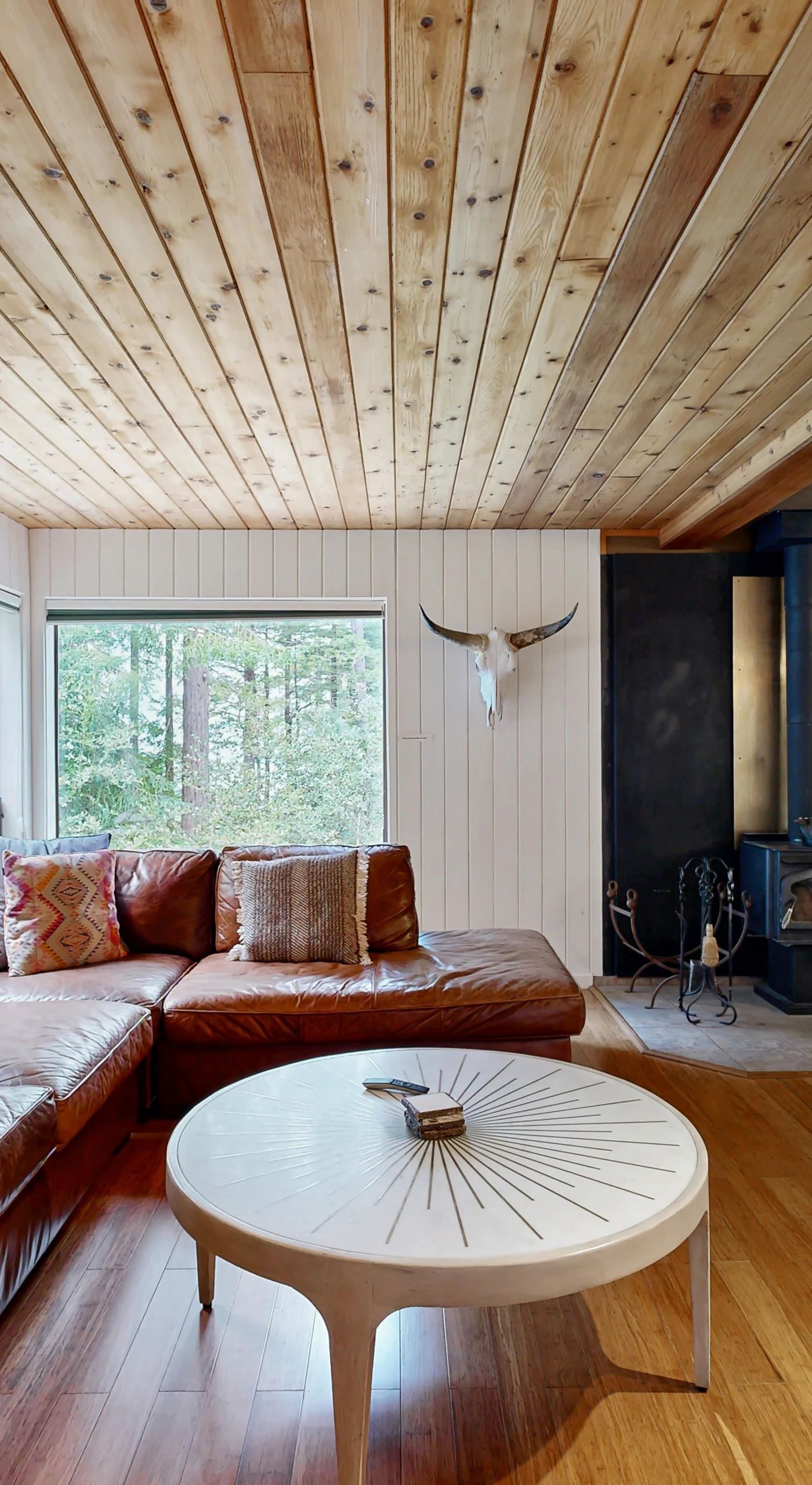 This inviting living room features a wood stove, perfect for cozy evenings spent with loved ones, sharing stories and laughter.