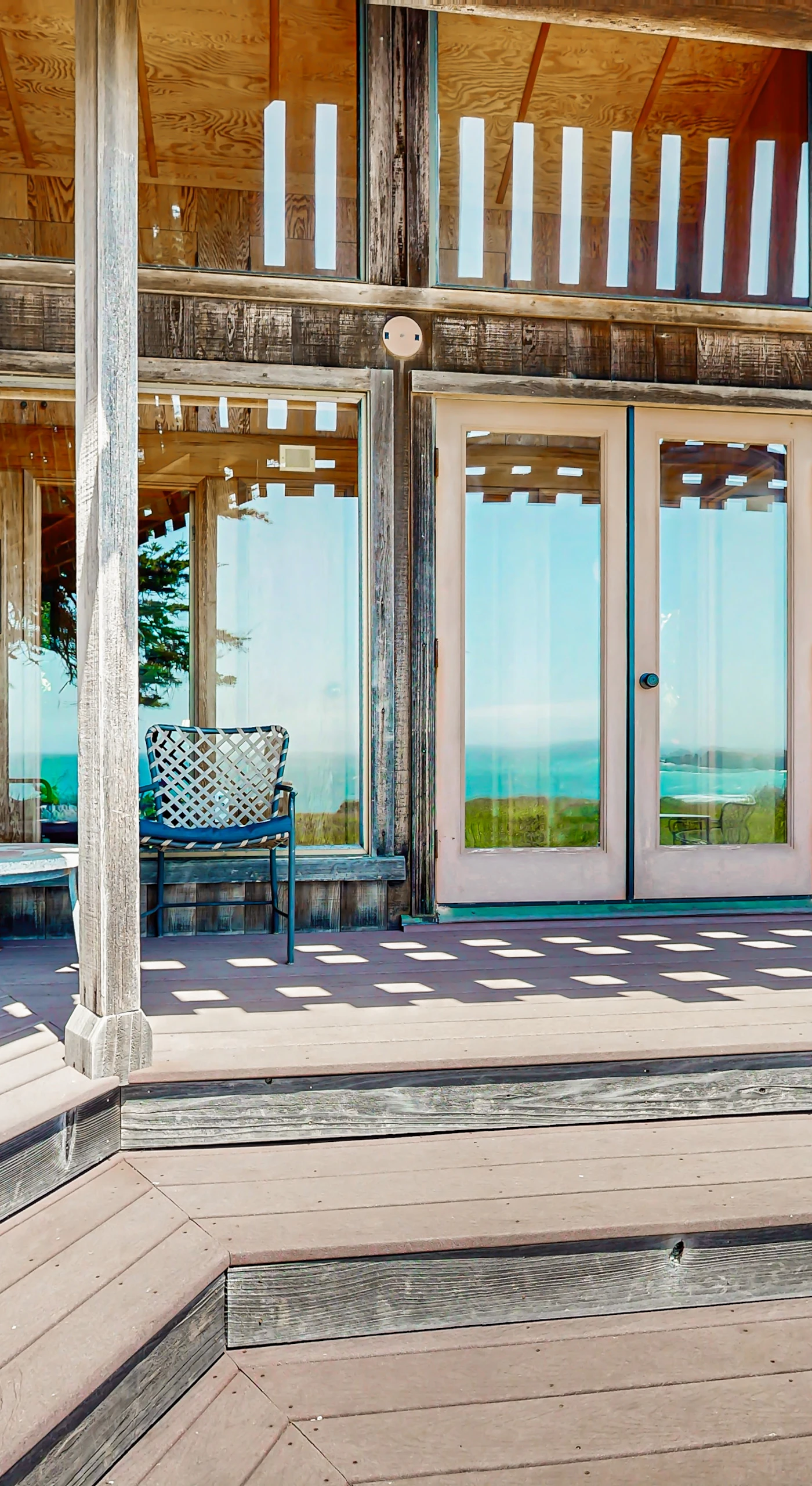 Step out onto the expansive deck, where comfortable seating invites you to soak in ocean views and the beauty of coastal living.