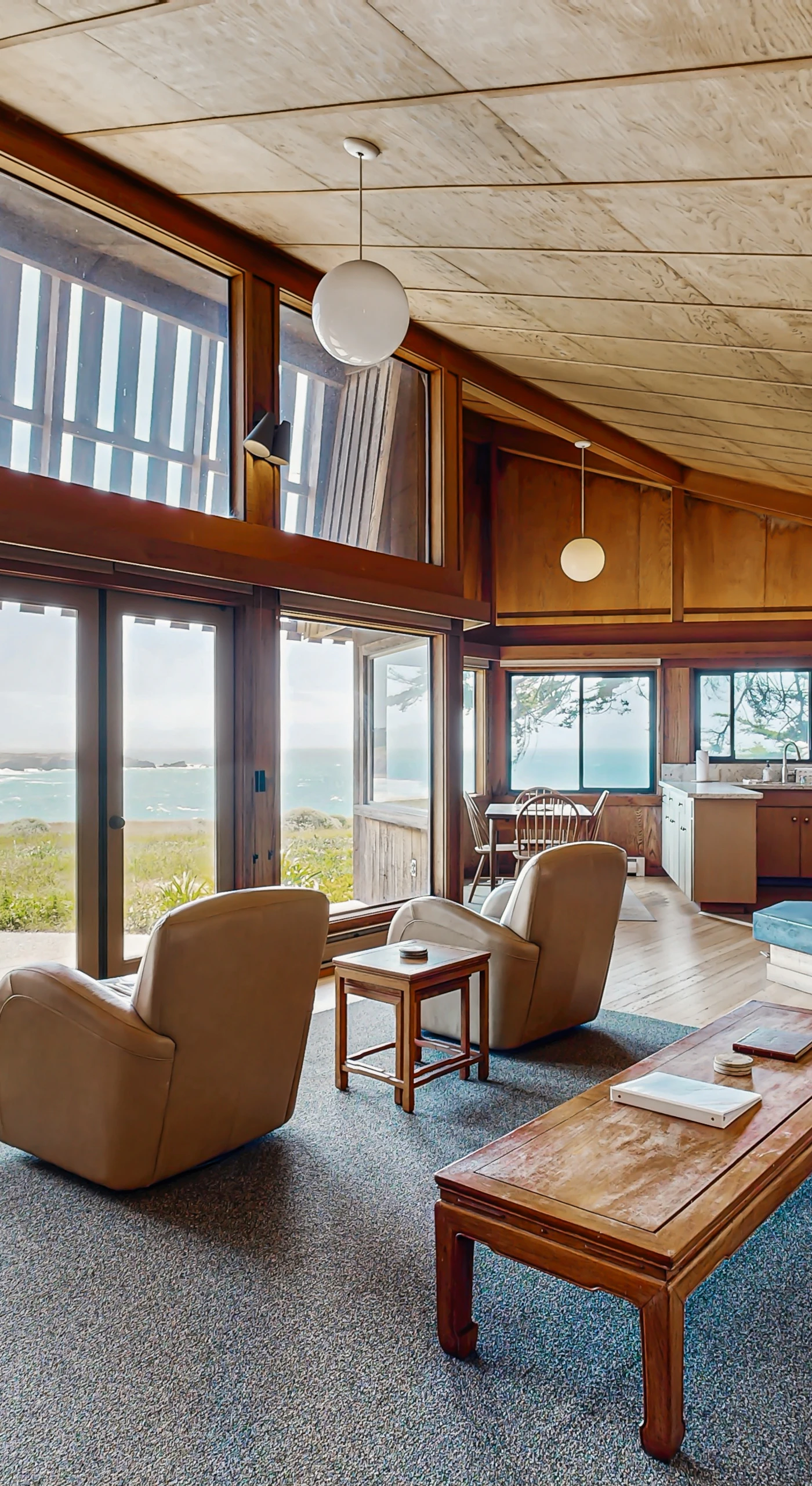 Relax in the spacious living room, where natural light pours in and the wood-burning fireplace invites cozy evenings.