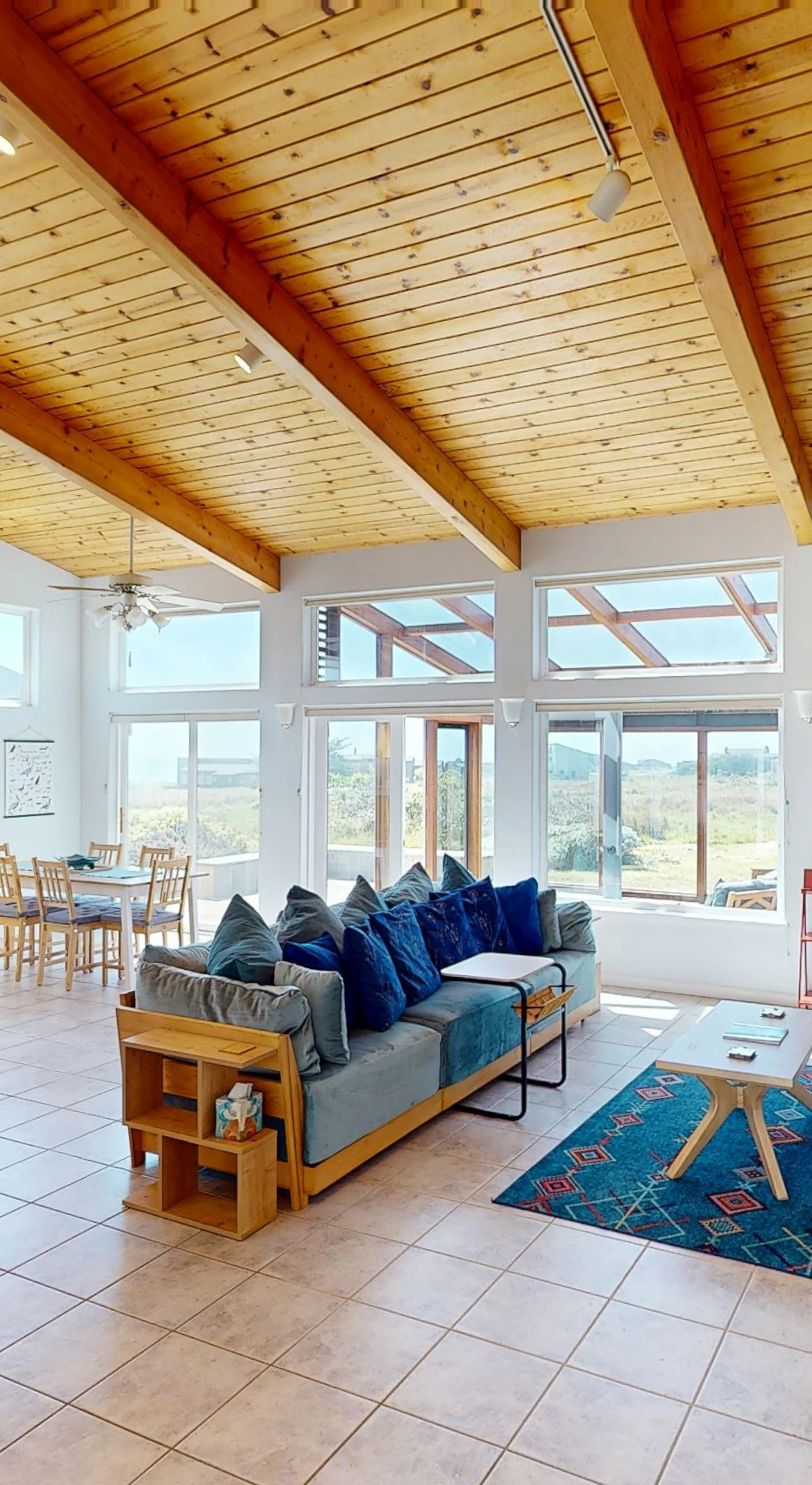 Gather in the spacious living room, where vaulted ceilings and natural light create an inviting atmosphere for unforgettable moments.