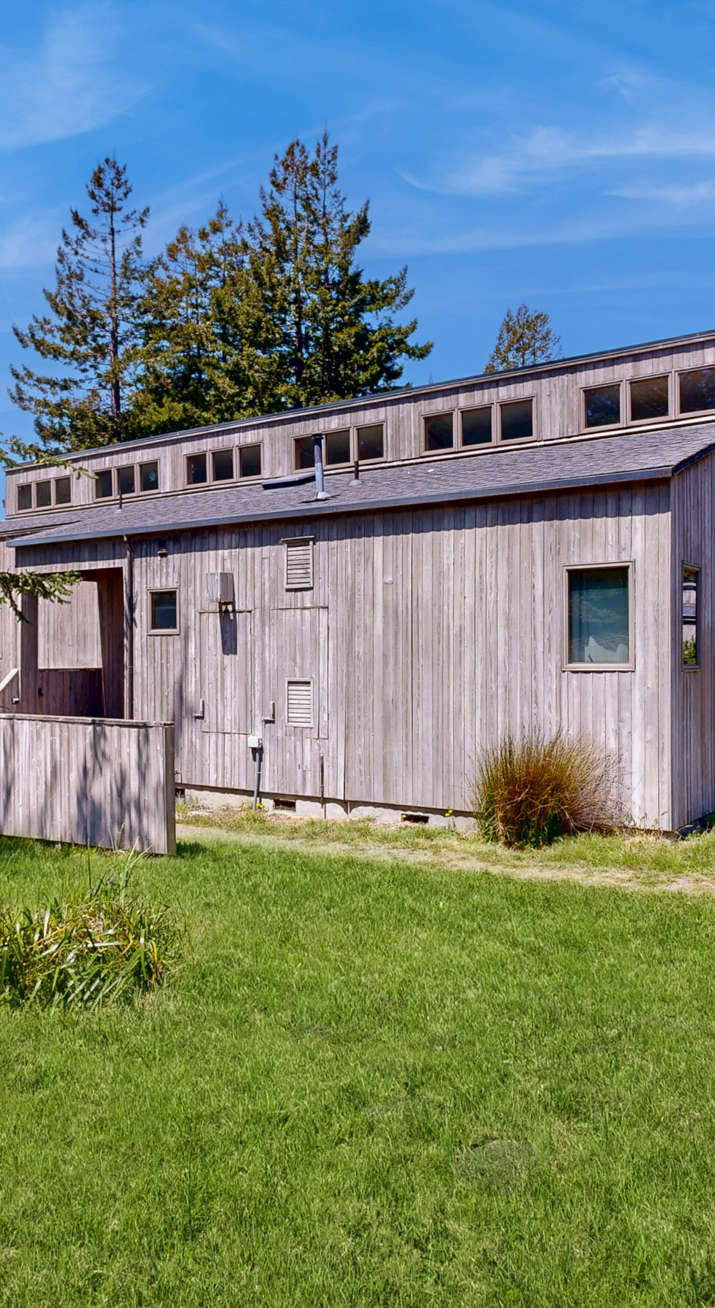 Nestled in lush greenery, Loon's Landing welcomes you with its charming exterior, inviting you to explore the serene beauty of Sea Ranch.
