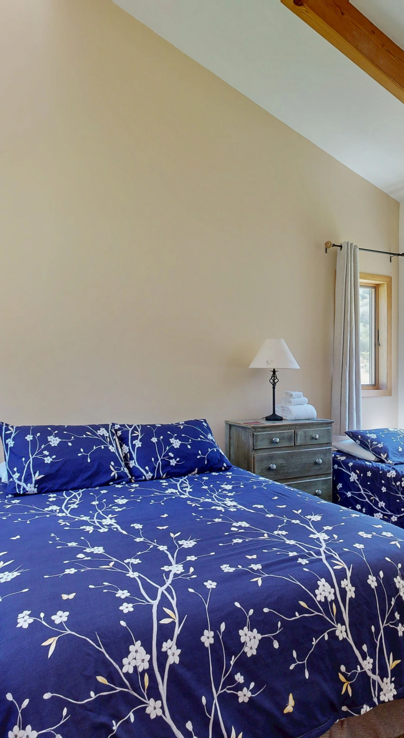 Retreat to the serene bedroom, featuring cozy bedding and ample natural light, inviting restful nights after your adventures.