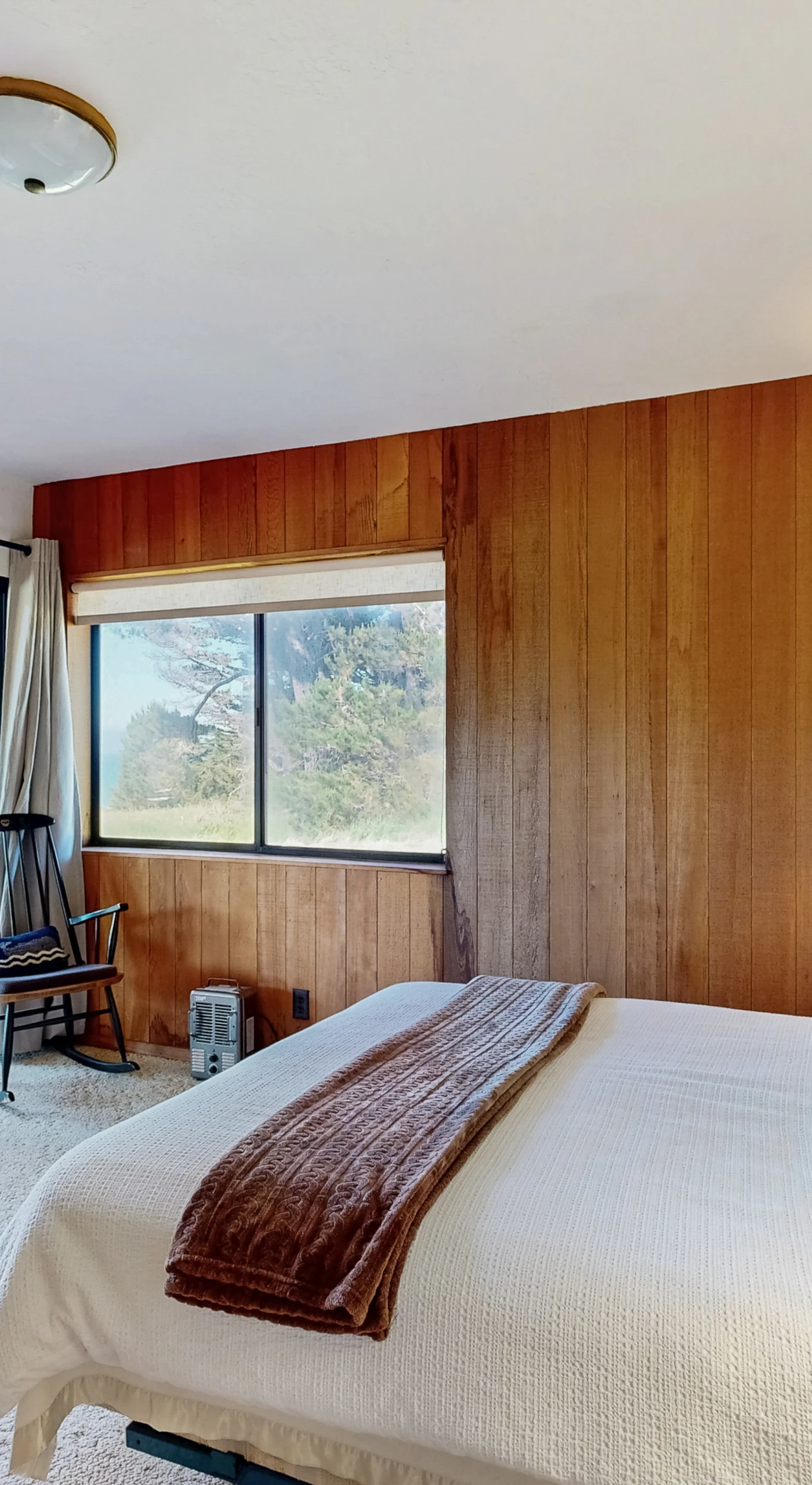 Retreat to the master bedroom, where natural wood accents and serene decor create a peaceful atmosphere for restful nights.