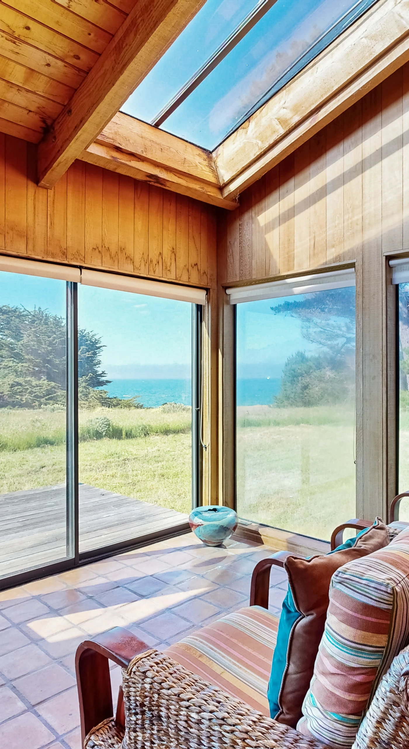 Bask in the inviting living room, where the expansive windows frame breathtaking ocean views, perfect for cozy evenings or lively gatherings.