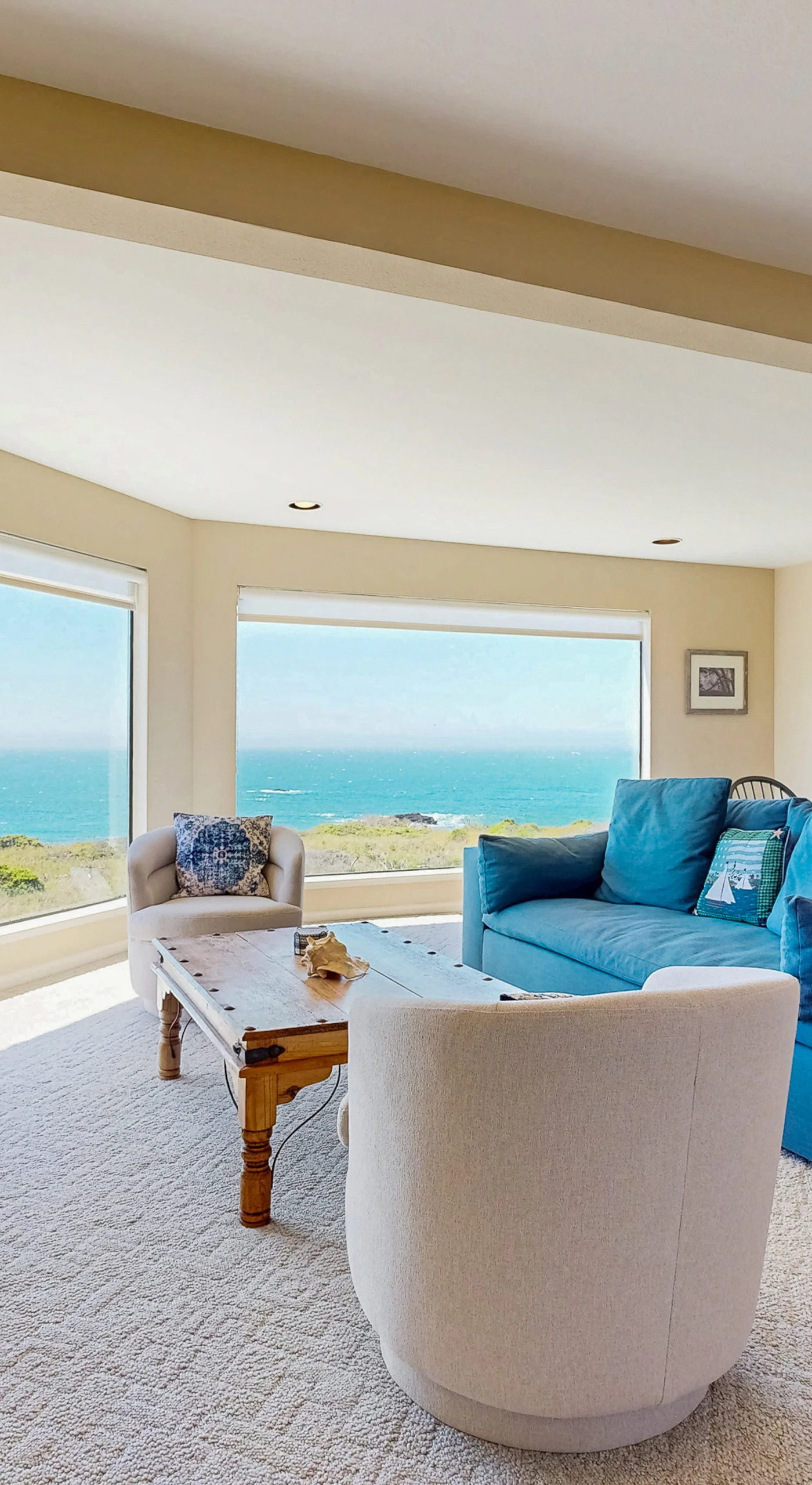 Bask in the natural light of the spacious living room, where ocean views inspire relaxation and cozy gatherings.