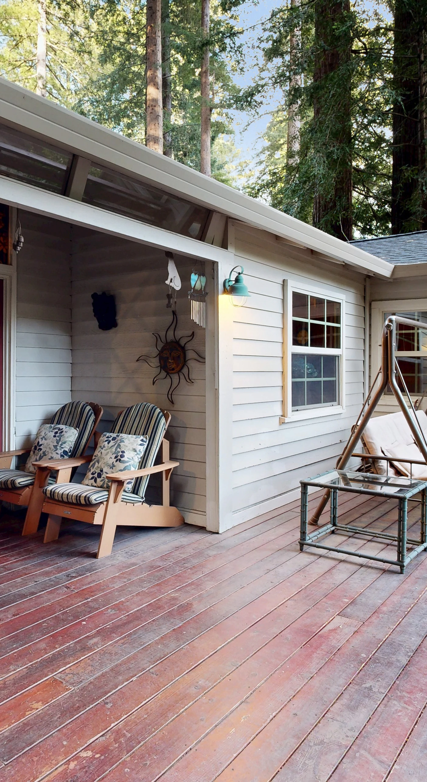 Step onto your spacious redwood deck with a porch swing, Adirondack seating, and a covered BBQ grill for evening cookouts.