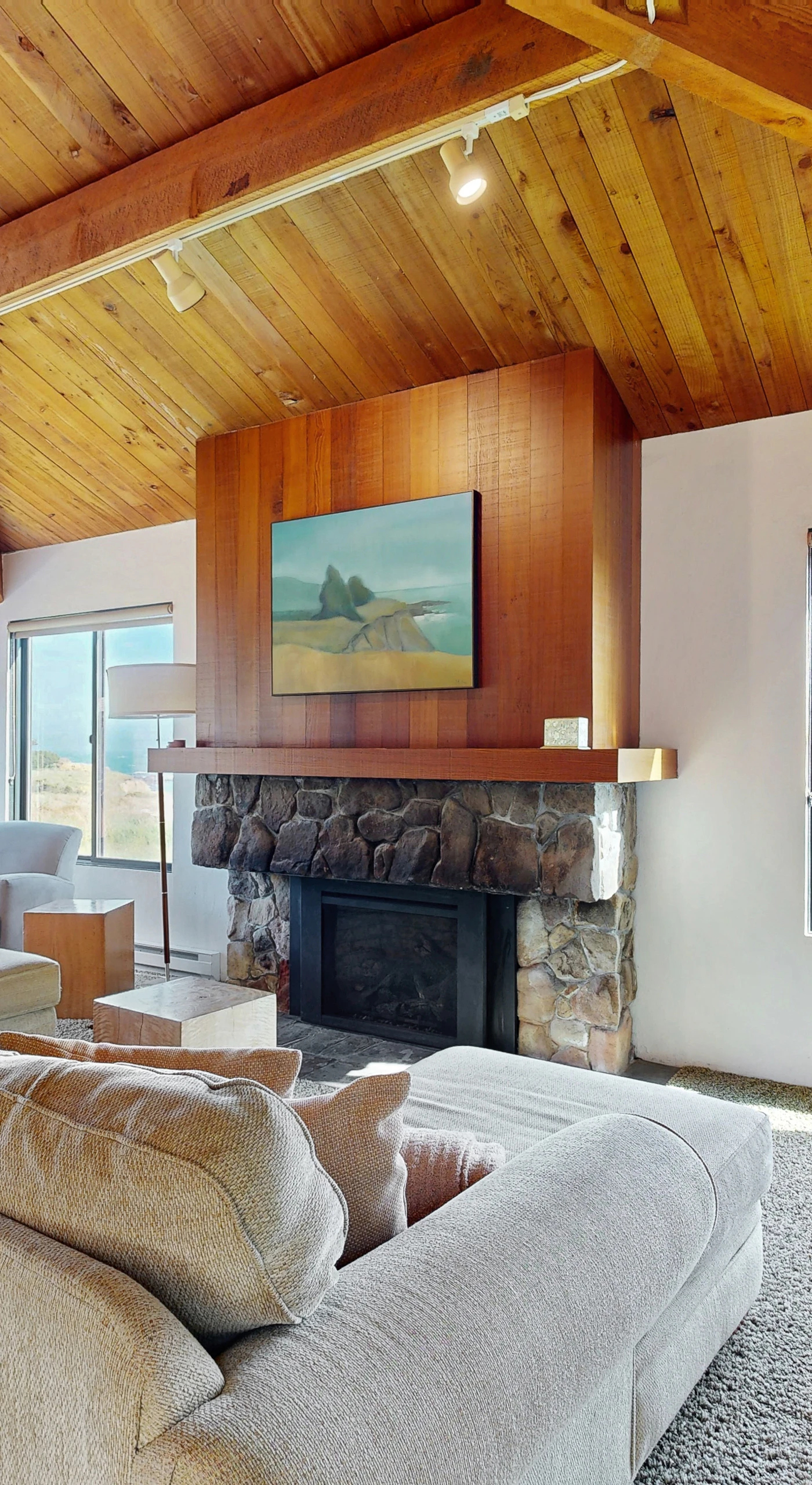 Morning light fills the living room, inviting you to unwind by the gas fireplace while gazing out at the breathtaking ocean horizon.