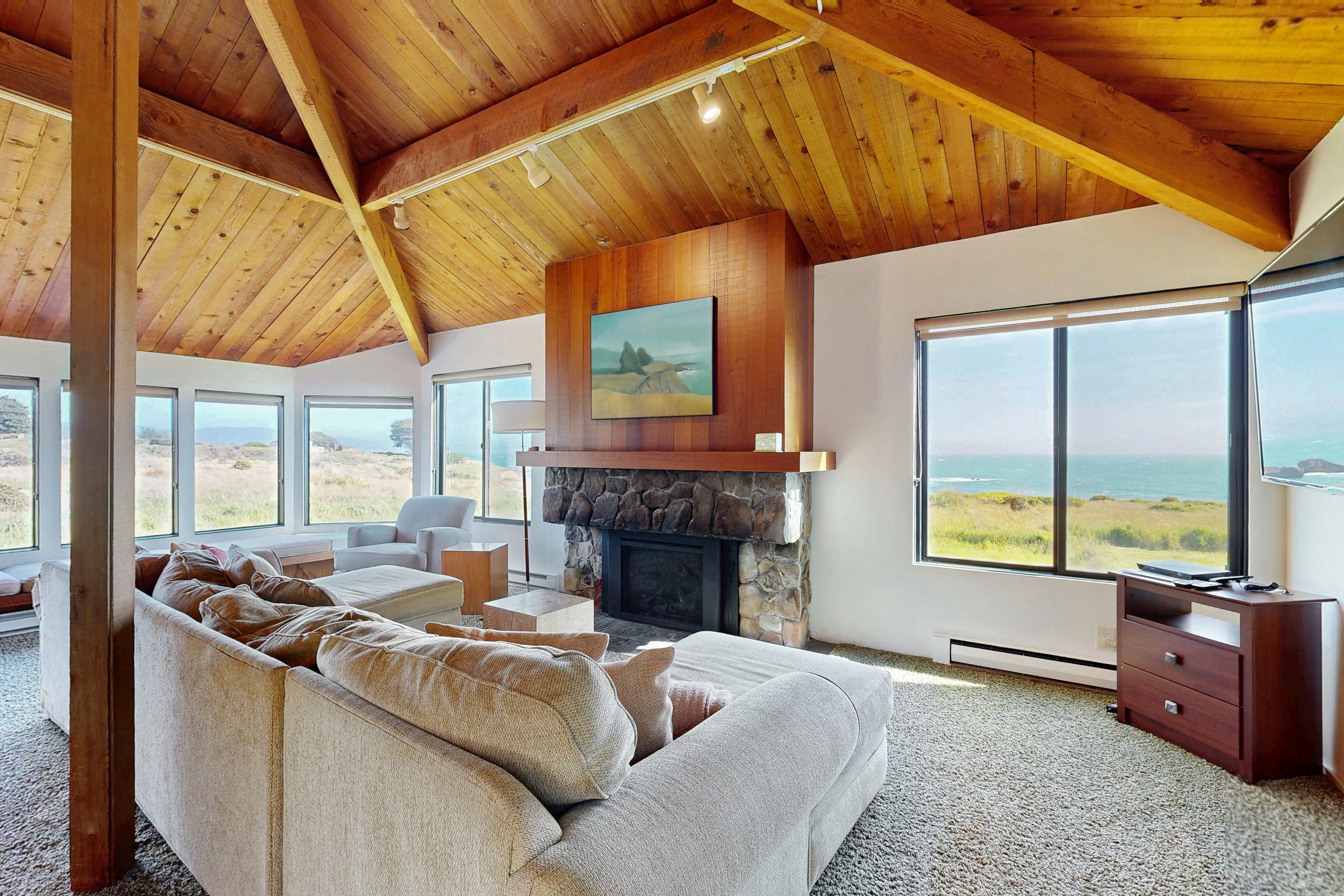 Morning light fills the living room, inviting you to unwind by the gas fireplace while gazing out at the breathtaking ocean horizon.