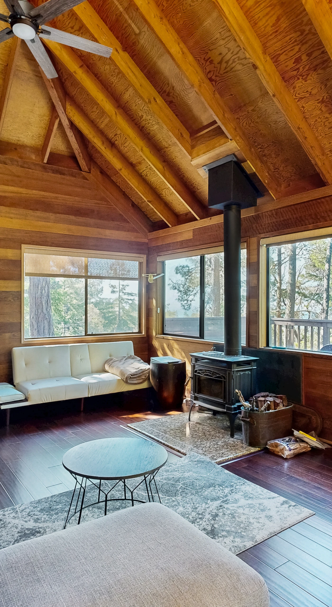 Morning light fills this cozy living room, inviting you to curl up with a book or enjoy the ocean views through expansive windows.