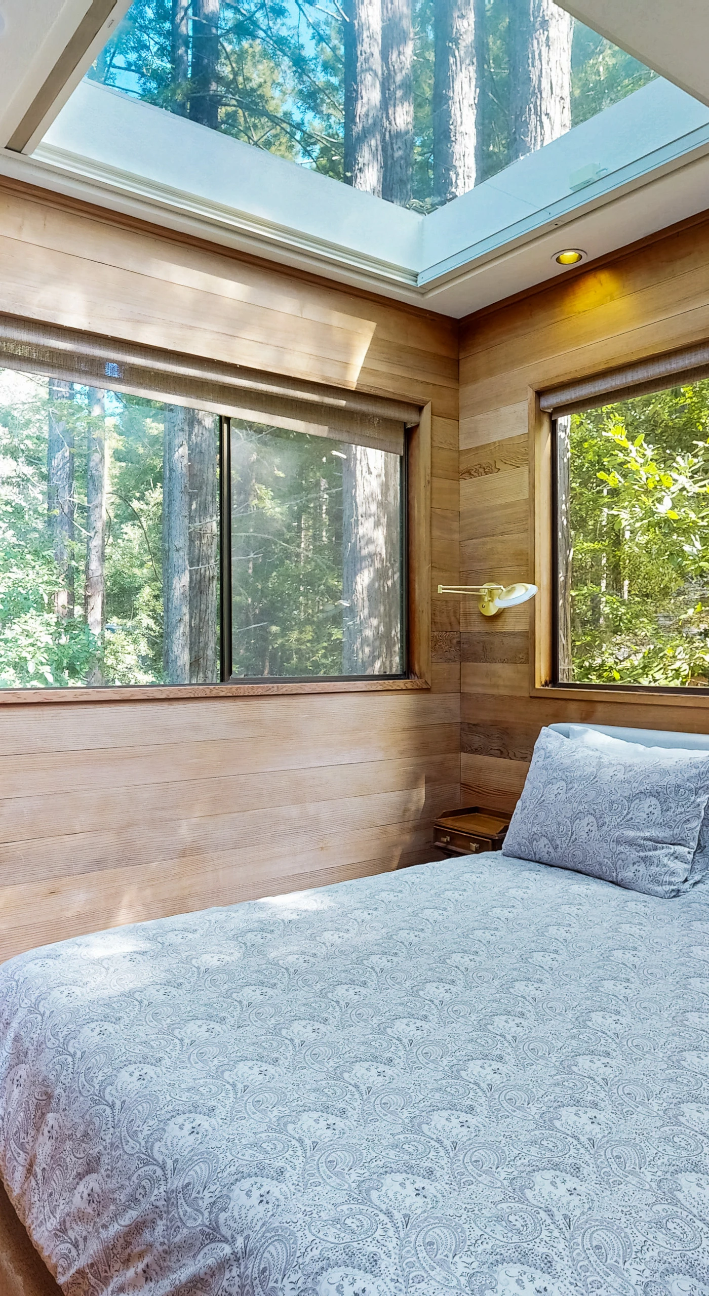 Your peaceful retreat awaits in this tranquil bedroom, where natural light pours in through skylights, creating a serene atmosphere.