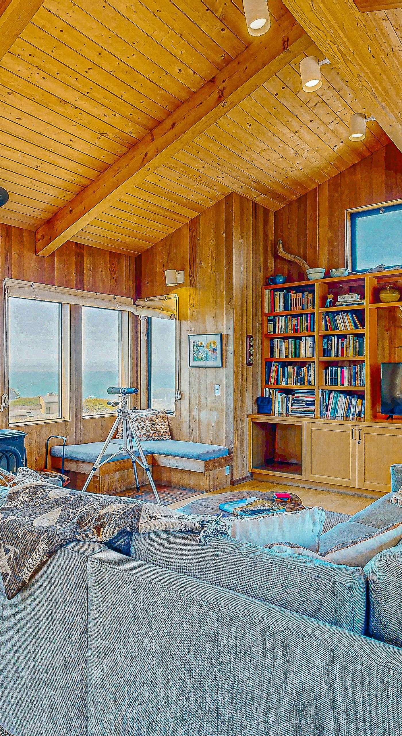 Breathe in the coastal air as you lounge in the cozy living room, where every window frames a piece of paradise.