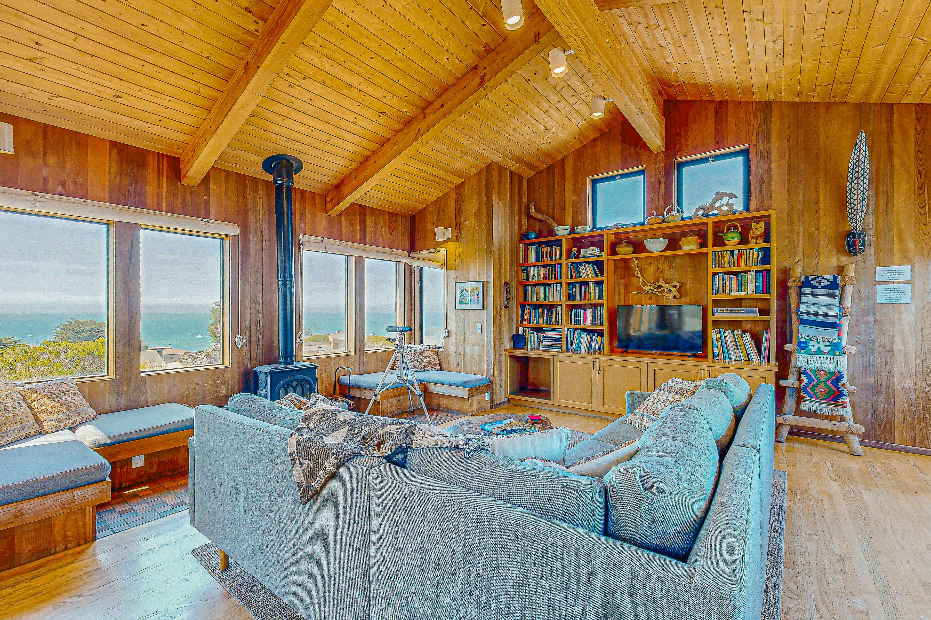 Breathe in the coastal air as you lounge in the cozy living room, where every window frames a piece of paradise.