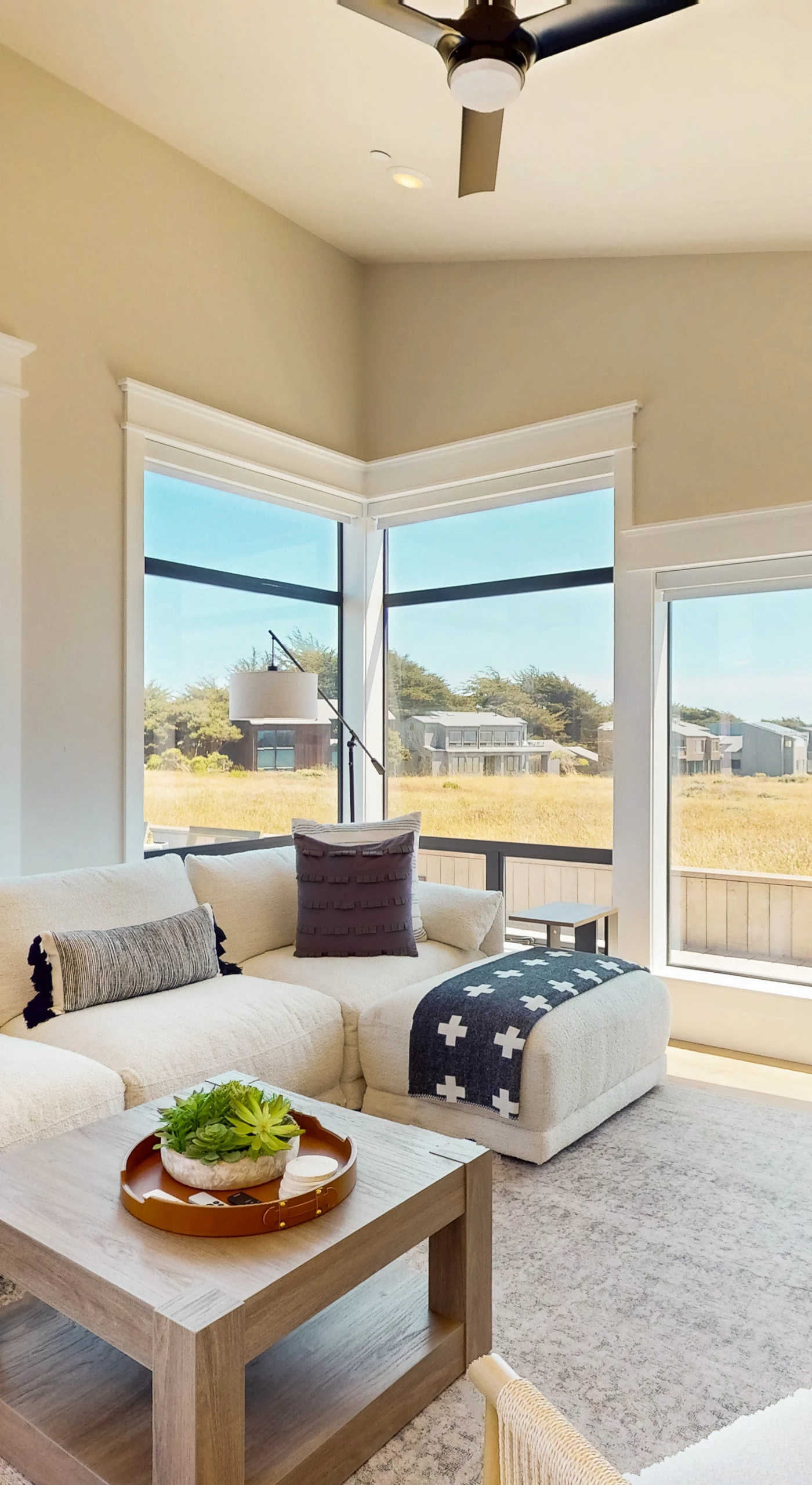 Morning light fills the living room, inviting you to sip coffee while gazing out at nature.