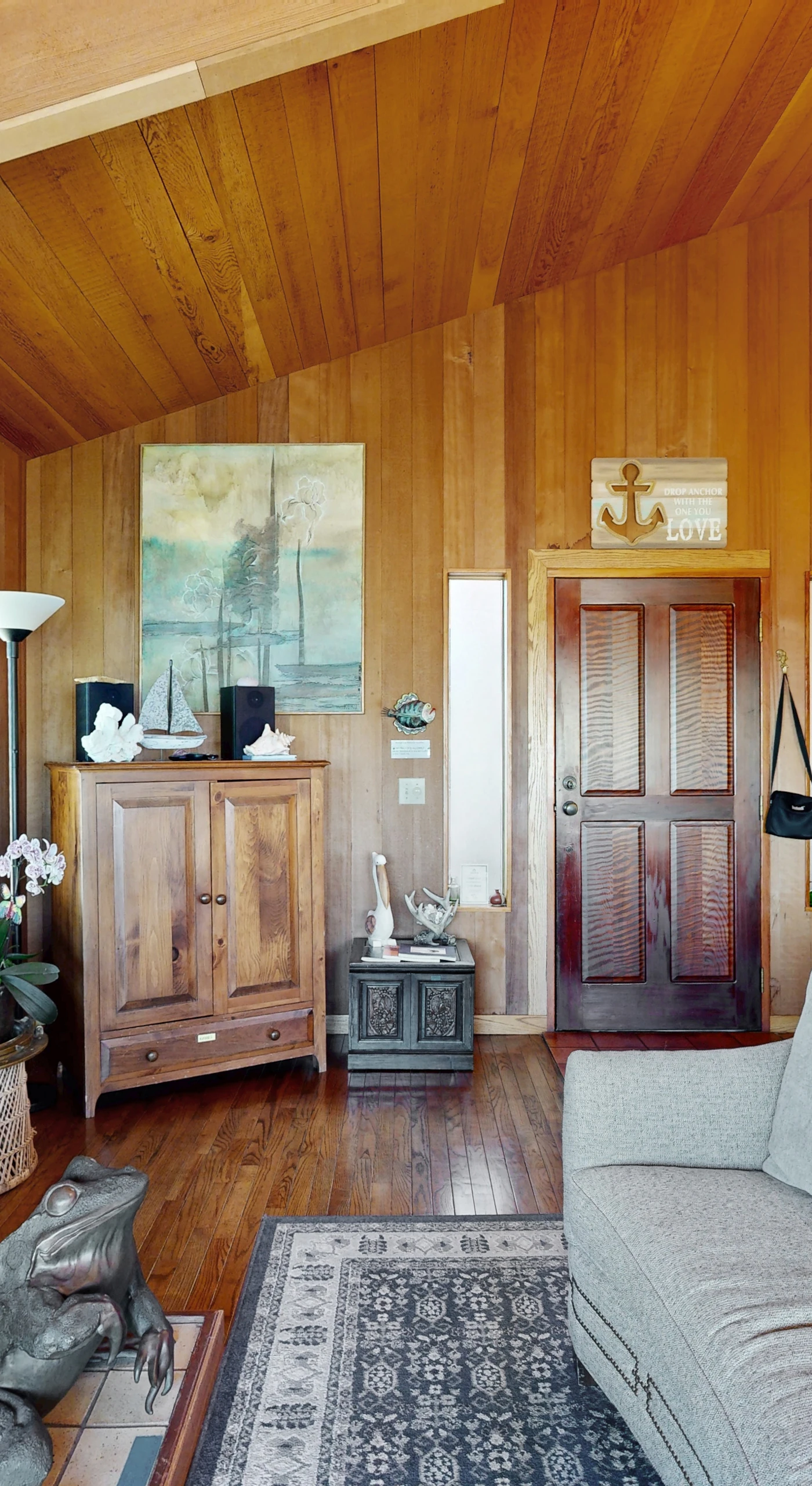 The cozy living room beckons for evenings spent with loved ones, surrounded by natural wood accents and inviting decor.