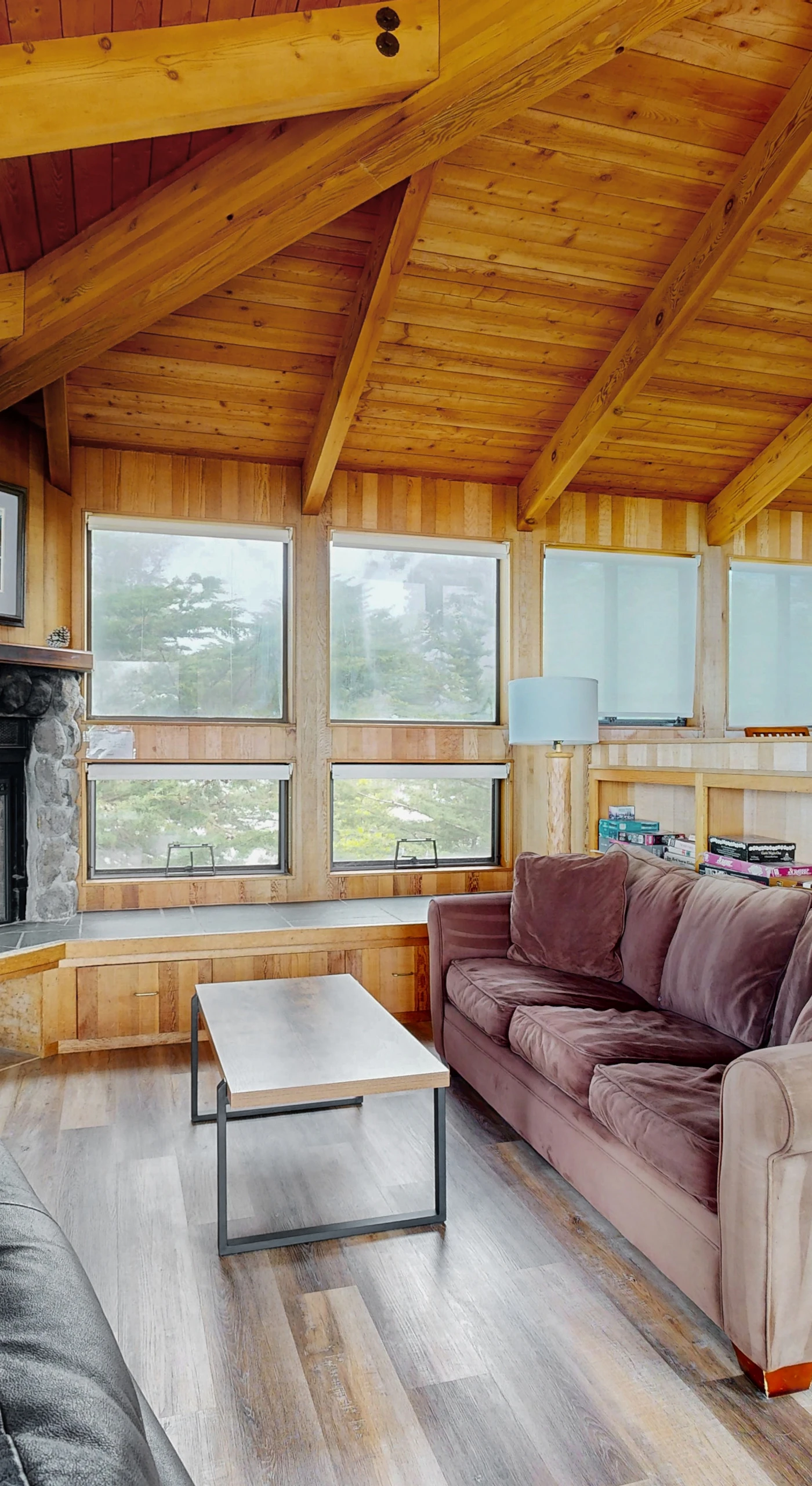 Gather around the stone fireplace in this inviting space, ideal for cozy evenings spent with loved ones.