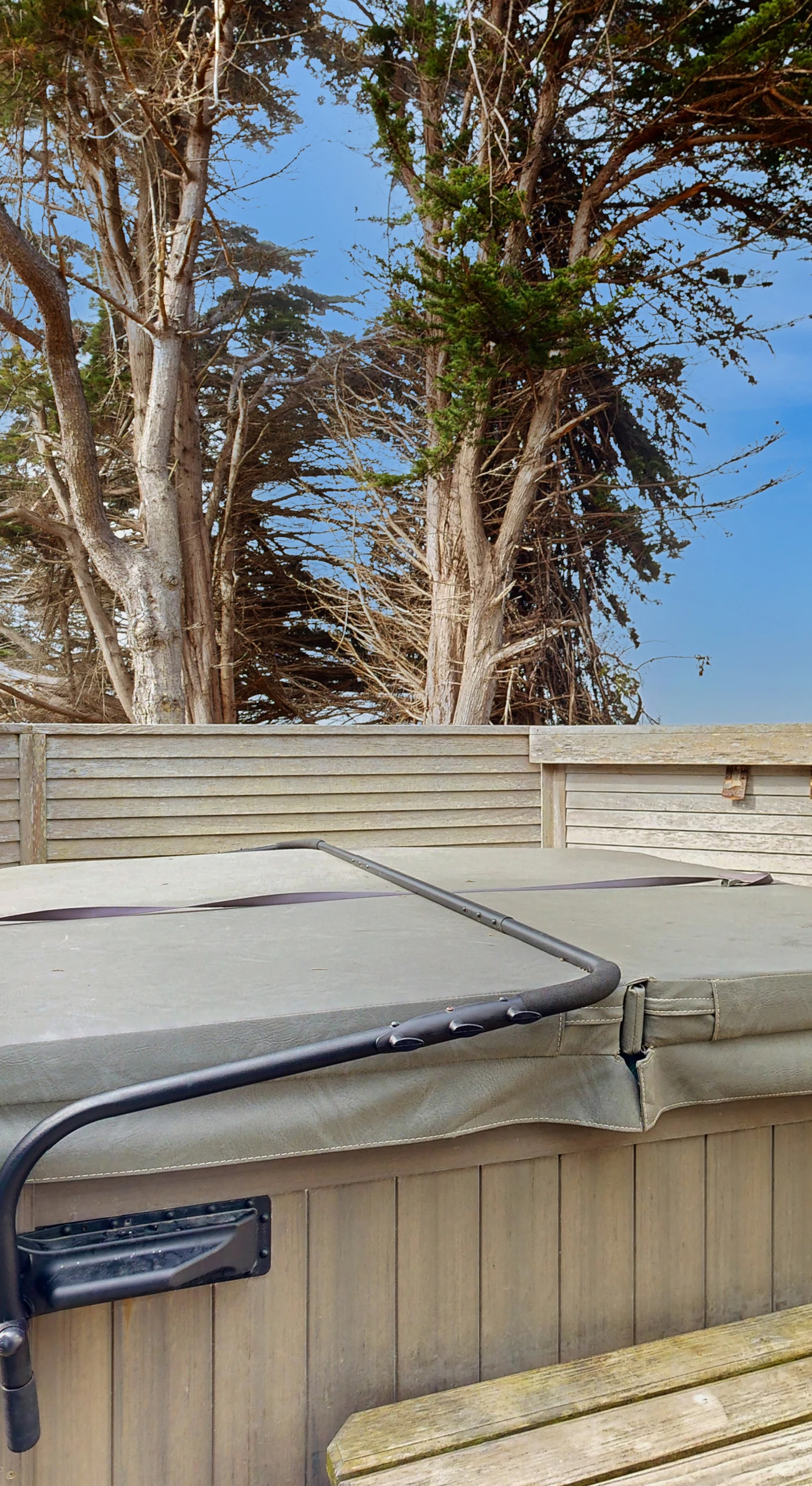 Indulge in a soak under the stars in your private hot tub, the ultimate way to unwind after a day of seaside adventures.