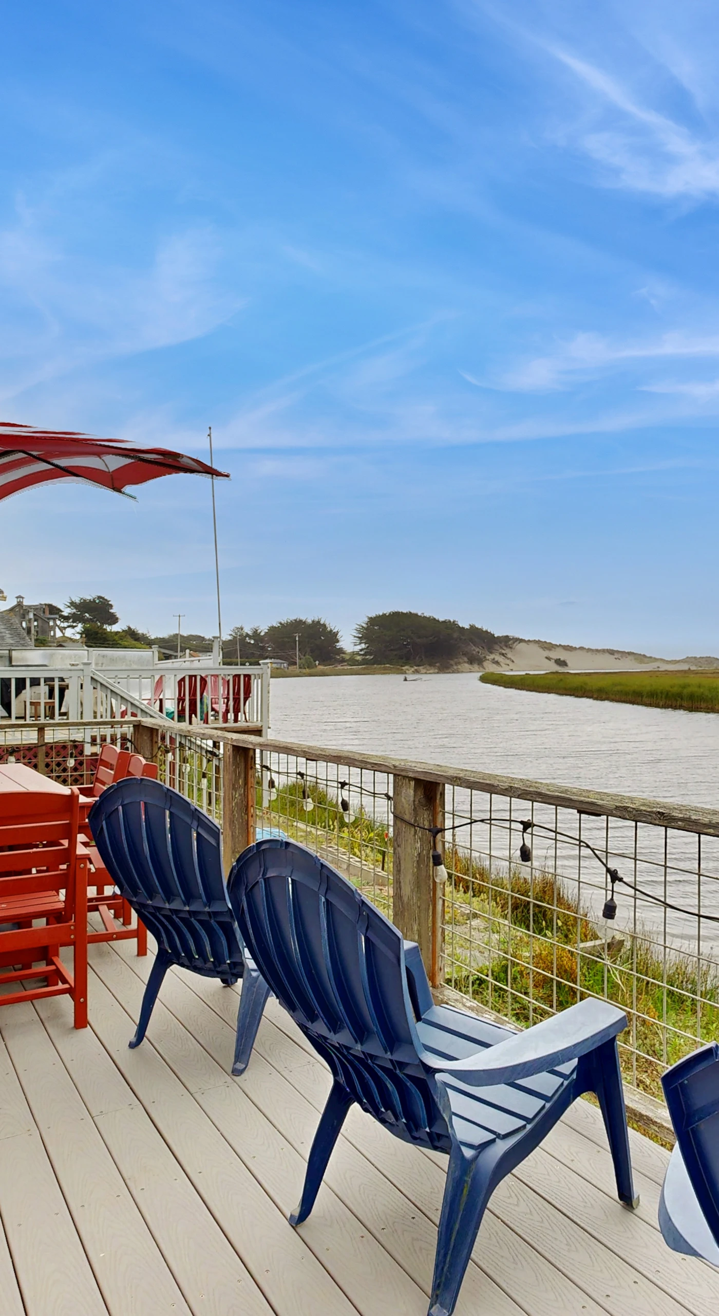 Dine al fresco on your private waterfront deck overlooking Bodega Bay's shimmering estuary, with Sonoma Coast hills in the distance.