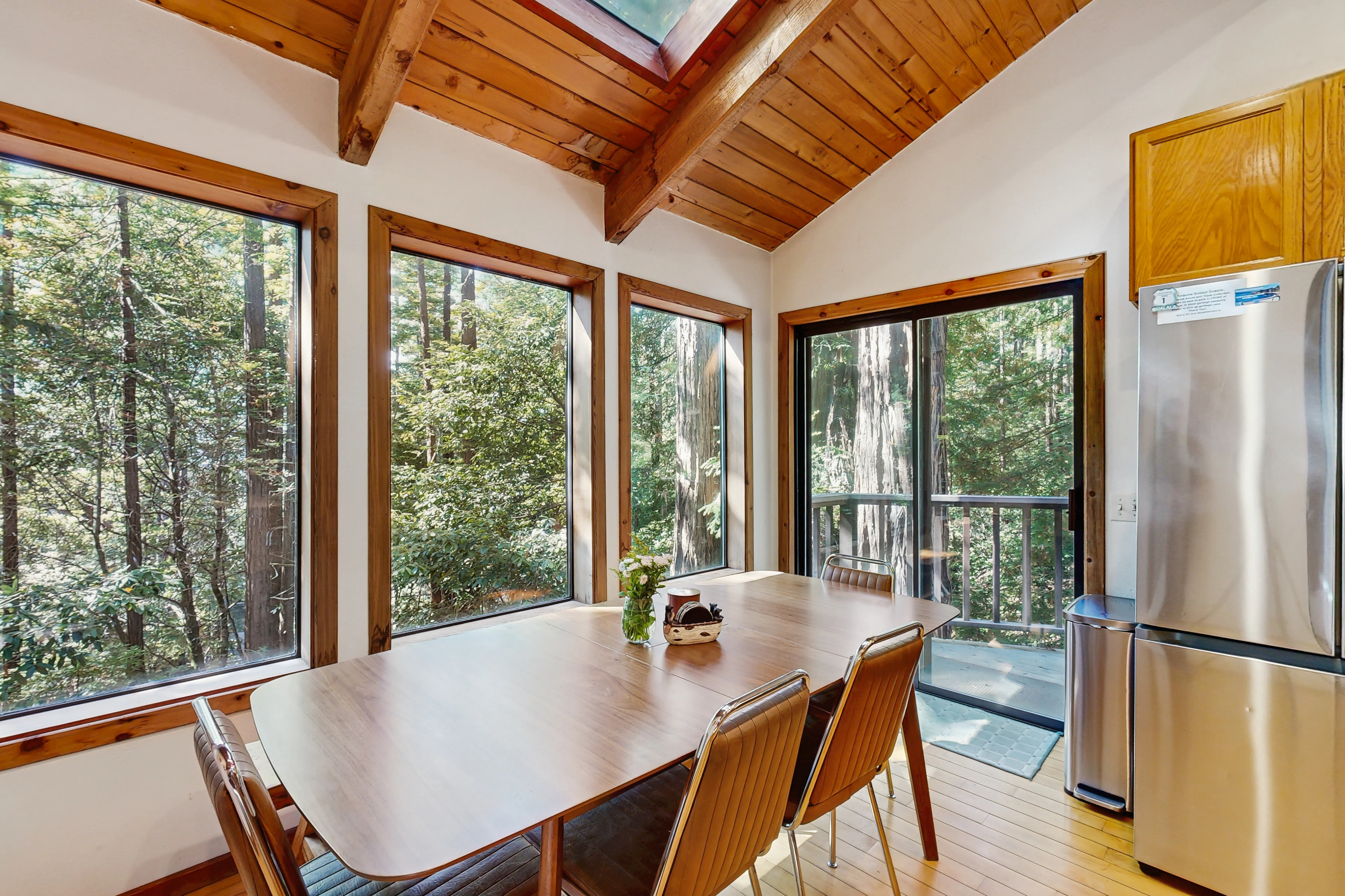 Dine surrounded by nature in this bright dining area, where the forest views make every meal feel like a special occasion.