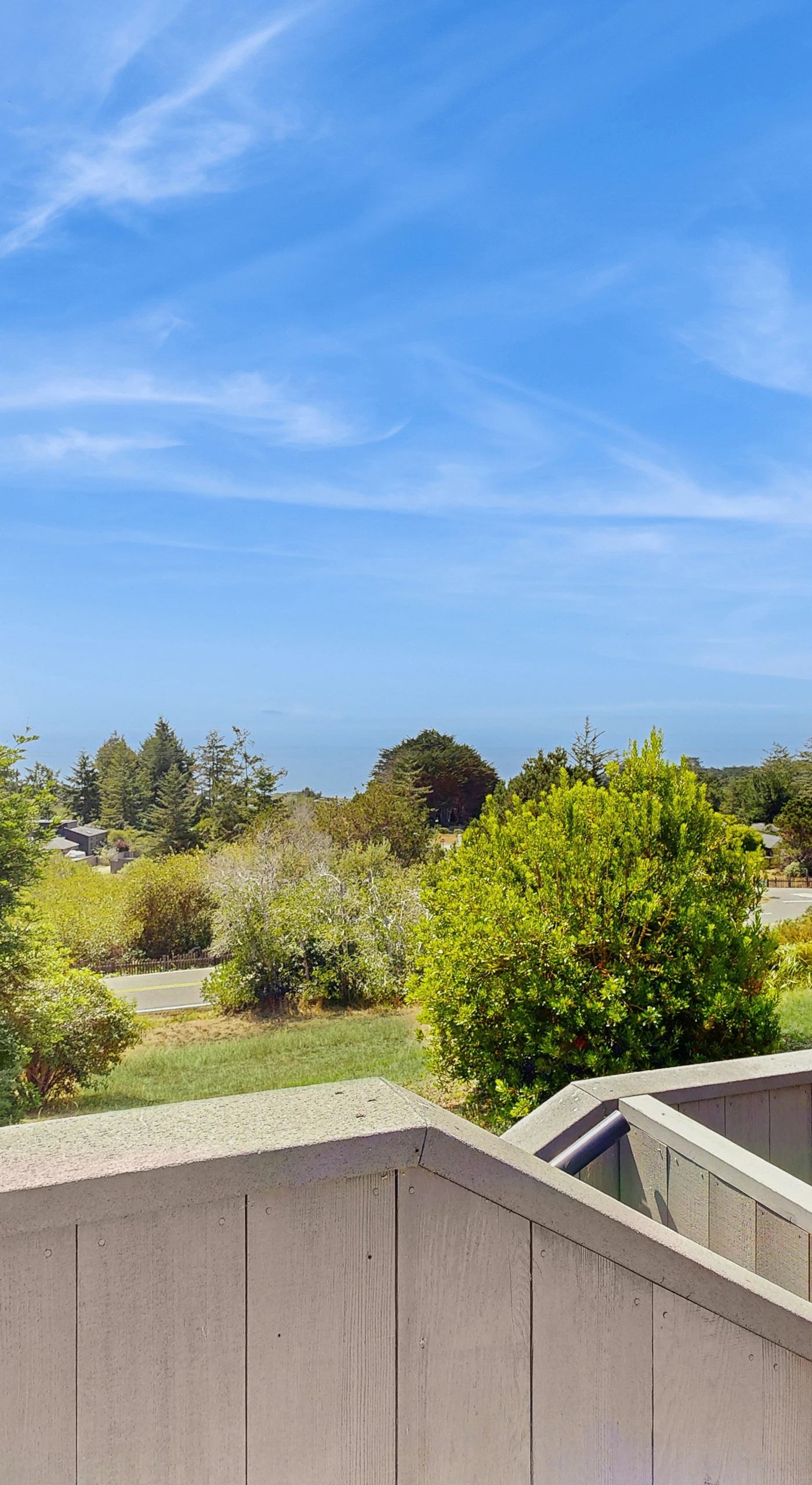 Gaze at the endless ocean from your private balcony, where lush greenery meets breathtaking views, inviting you to embrace the coastal lifestyle.