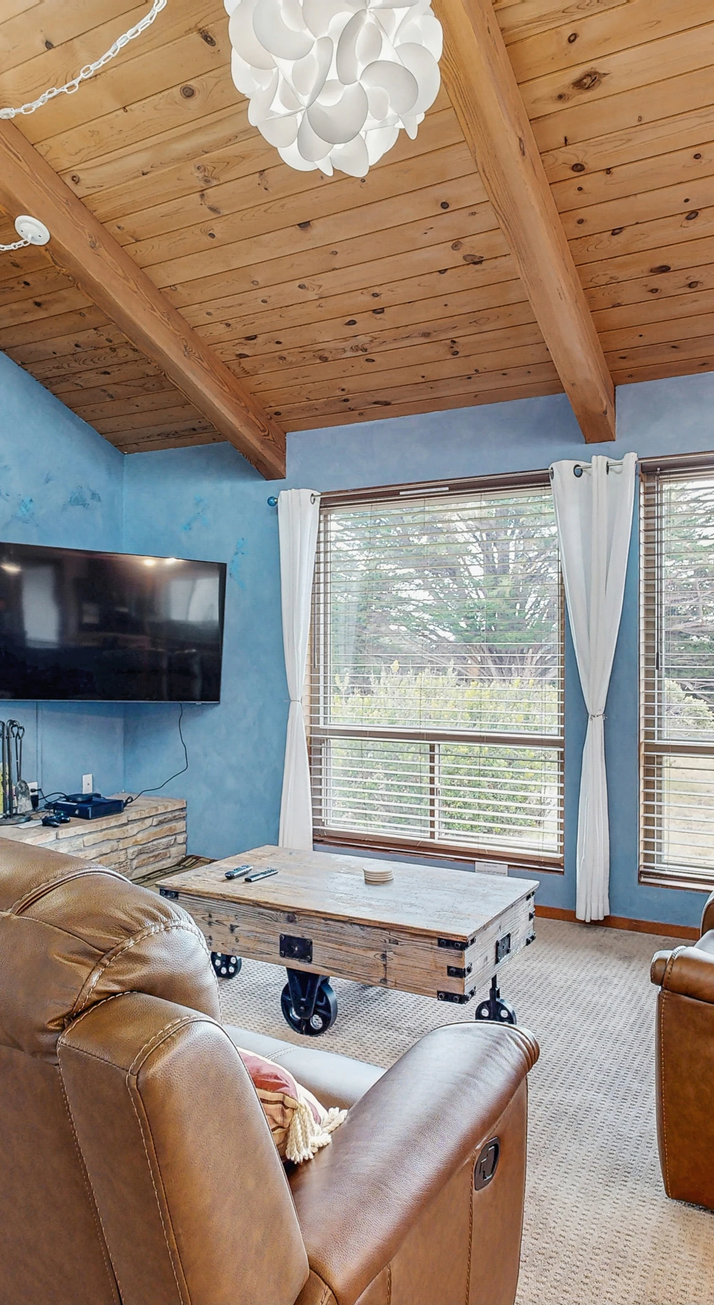Relax in the inviting living room, where the warmth of the fireplace and stunning views create the perfect space for cozy evenings.