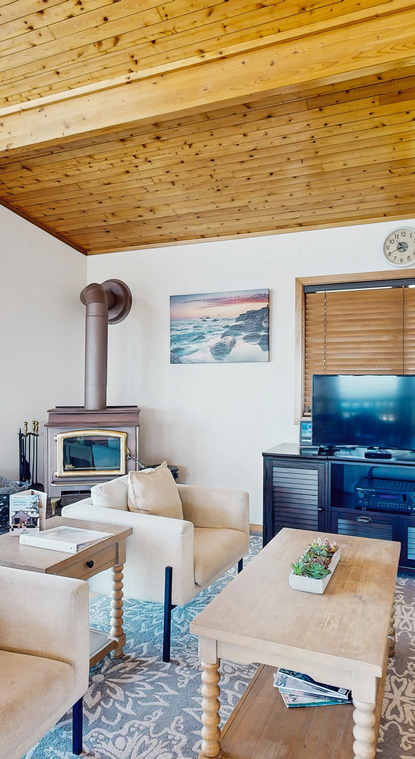Gather around the cozy living room, where natural light floods in, creating a warm space for relaxation and connection.