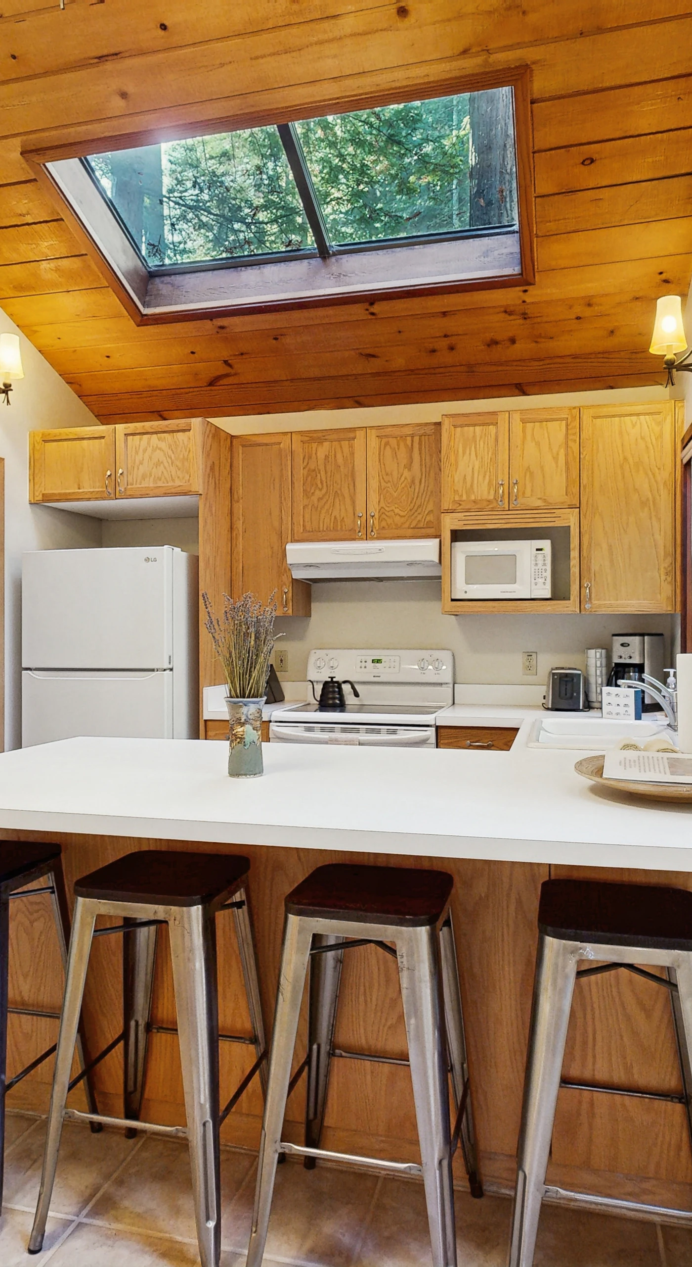 Craft delicious meals in this well-equipped kitchen, where natural light pours in, inspiring culinary creativity surrounded by nature.
