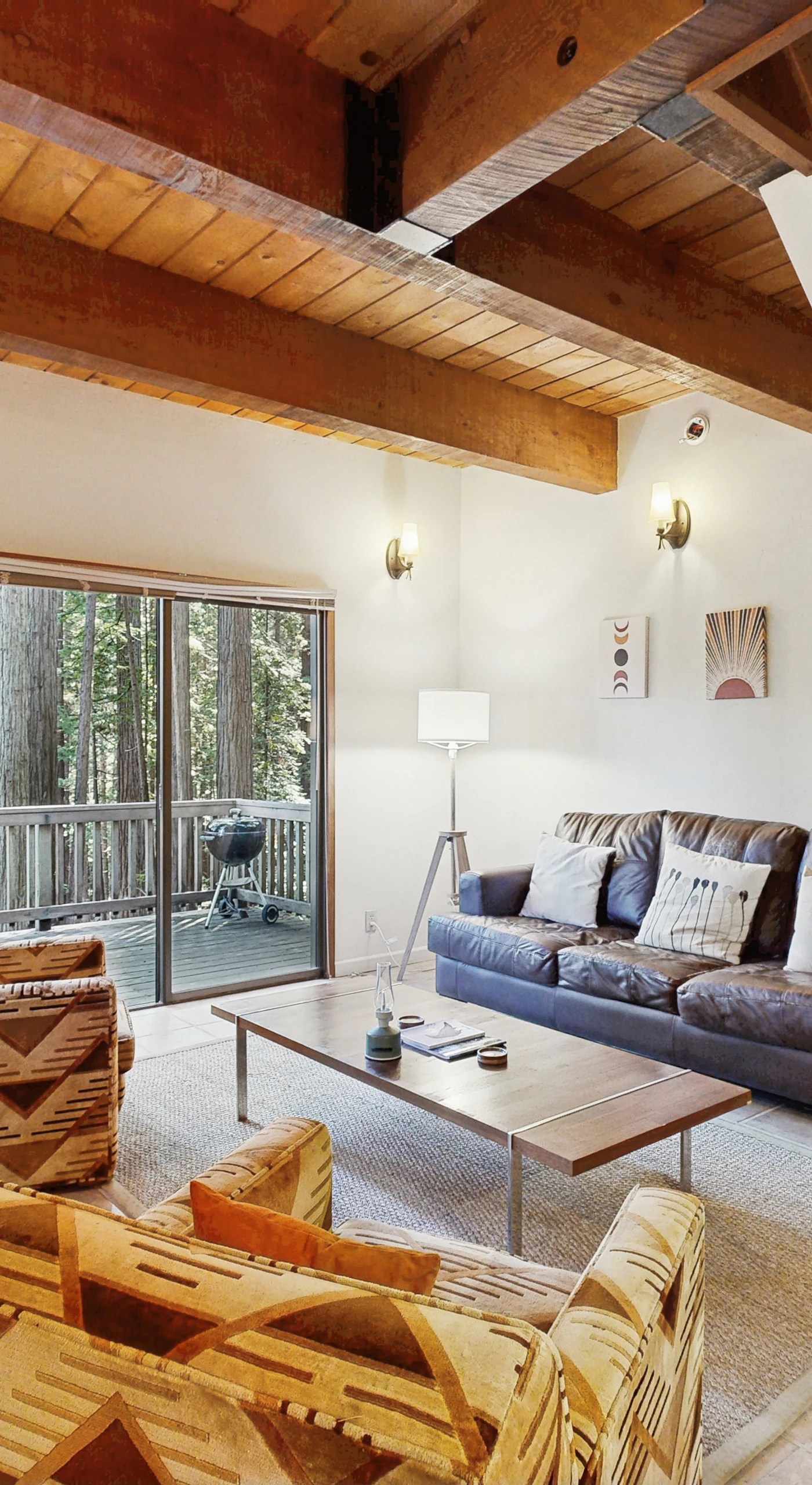 Bask in the warmth of the wood-burning fireplace while you unwind in this cozy living room, perfect for family gatherings or quiet evenings.