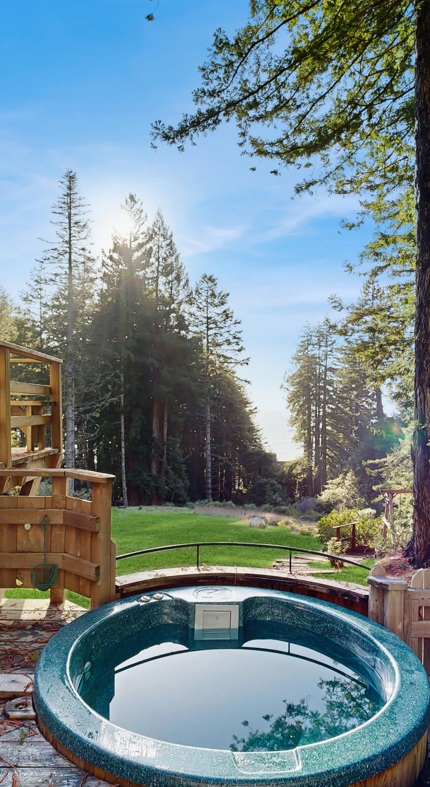 Soak in your private hot tub surrounded by serene redwoods, the perfect spot to unwind after a day of exploration.