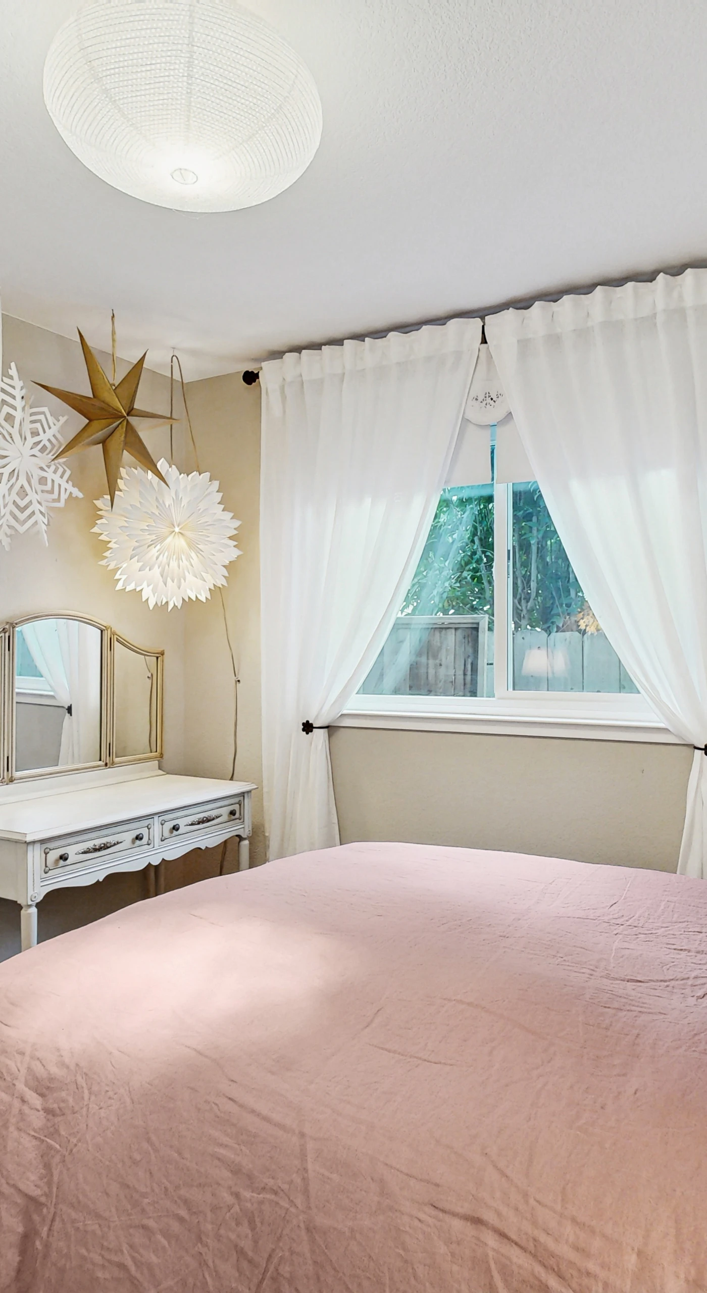 Drift off in your serene queen bedroom with a statement starburst pendant and soft blush linens — a restful Sonoma hideaway designed for deep sleep after a full day of wine country exploration.