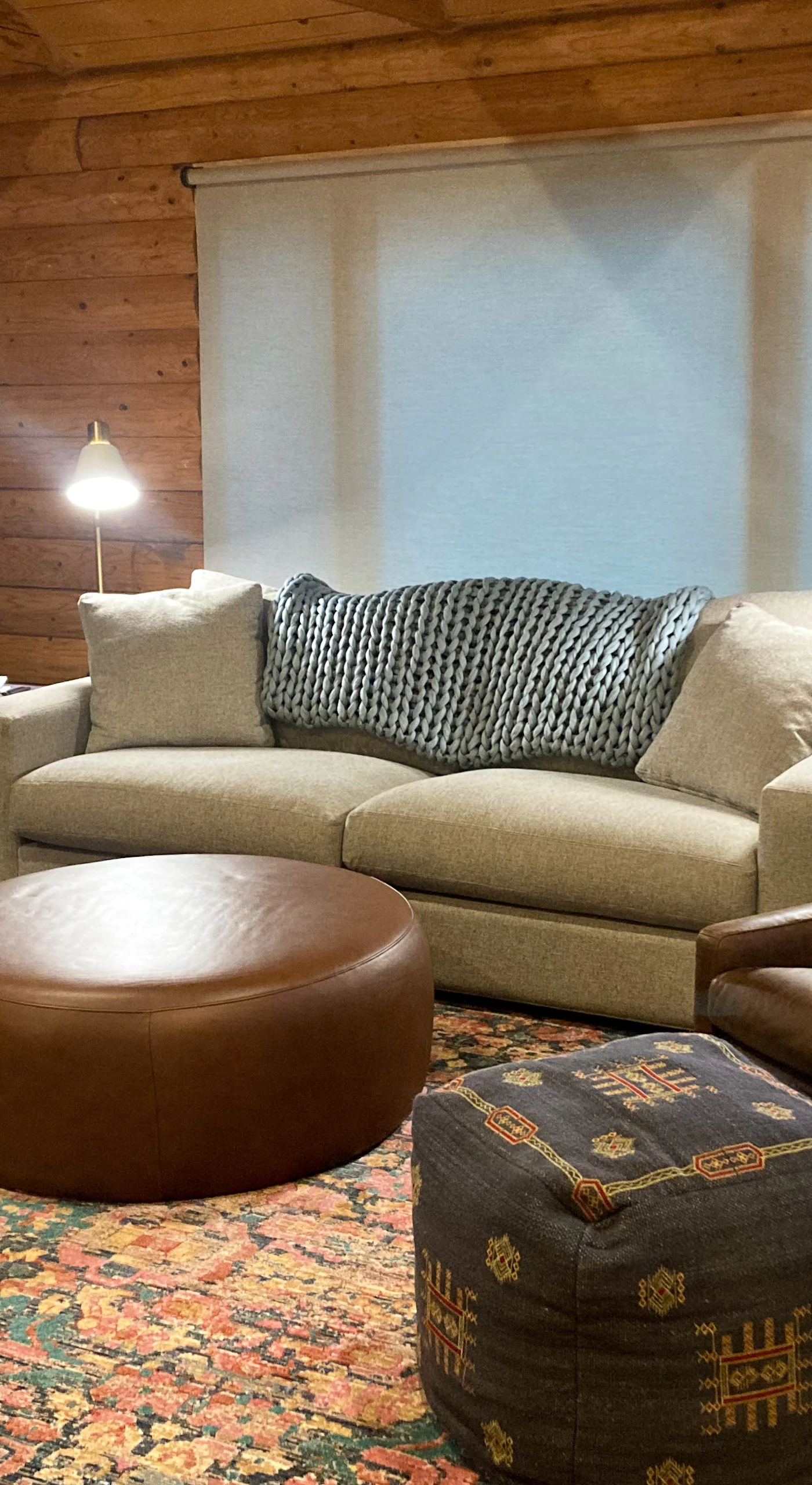 Bask in the warmth of the log cabin's living room, perfect for cozy evenings with friends or a quiet read by the window.