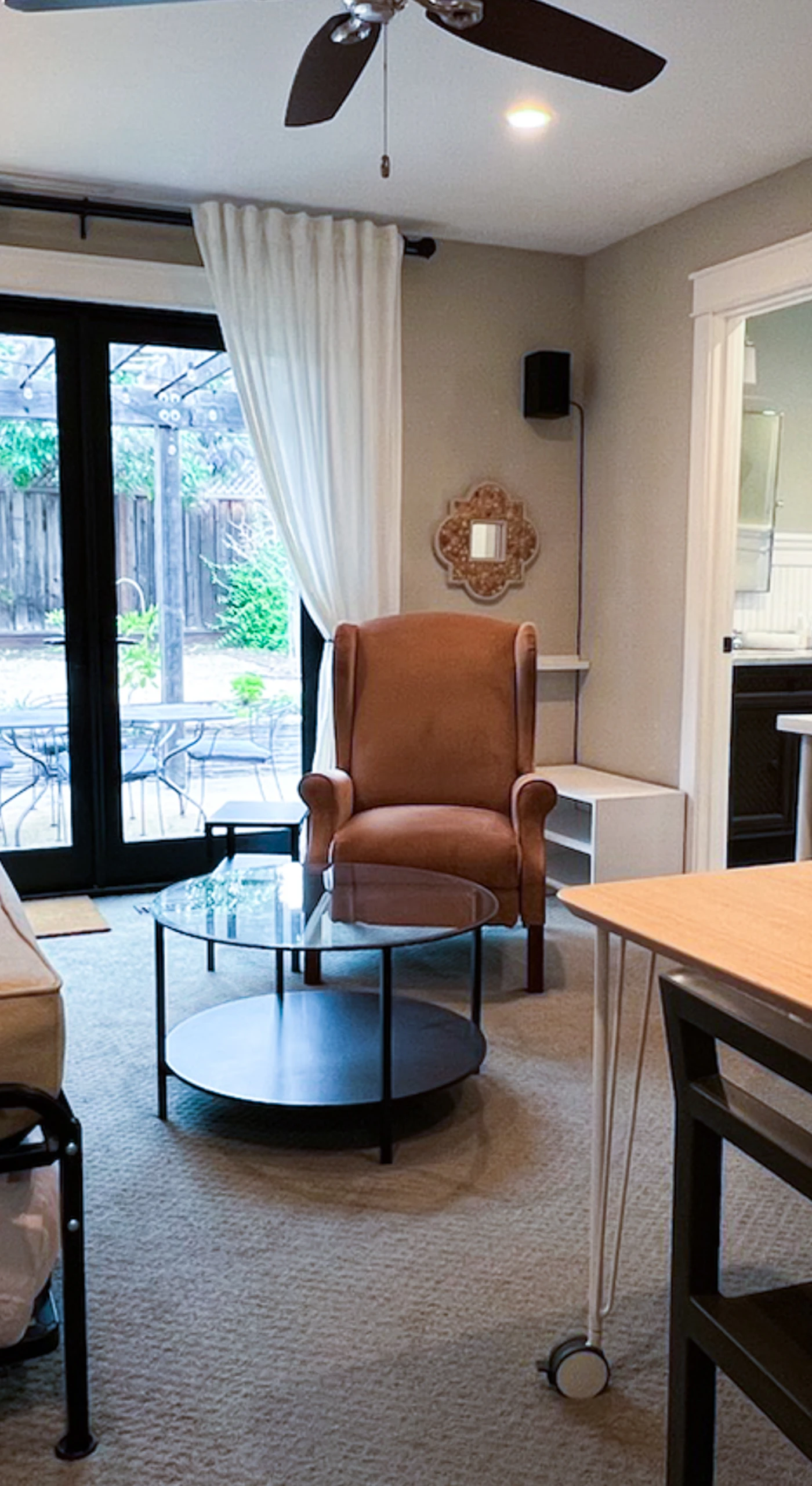 Settle into your stylish Sonoma wine country studio — a cozy daybed with plush pillows, leather wingback chair, and wall-mounted TV make this your perfect retreat after a day exploring local vineyards.
