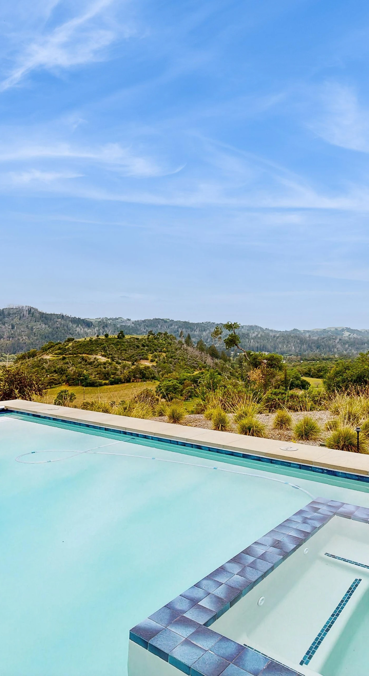 Glide into your private heated pool and spa perched above the Calistoga hills — your personal infinity of vineyard-dotted mountains stretching to the horizon.