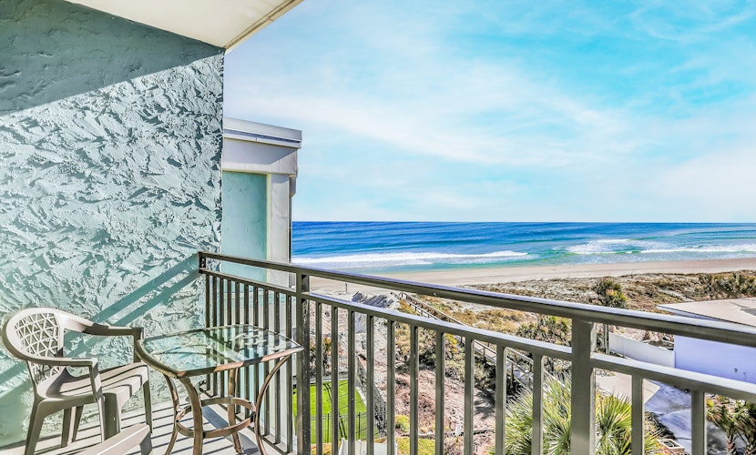 Polished oceanfront condo with pool access, private balcony & washer/dryer