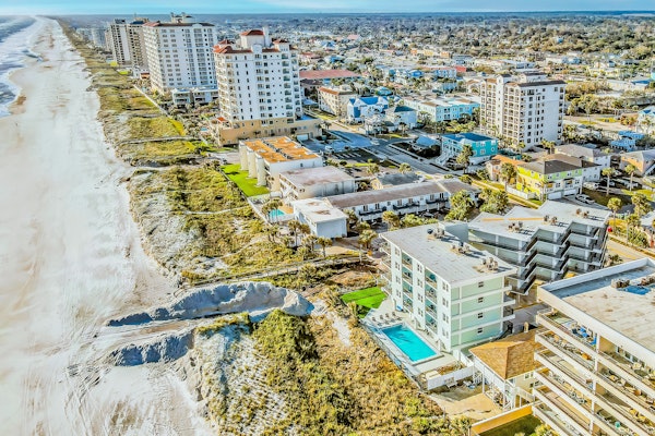 Polished oceanfront condo with pool access, private balcony & washer/dryer